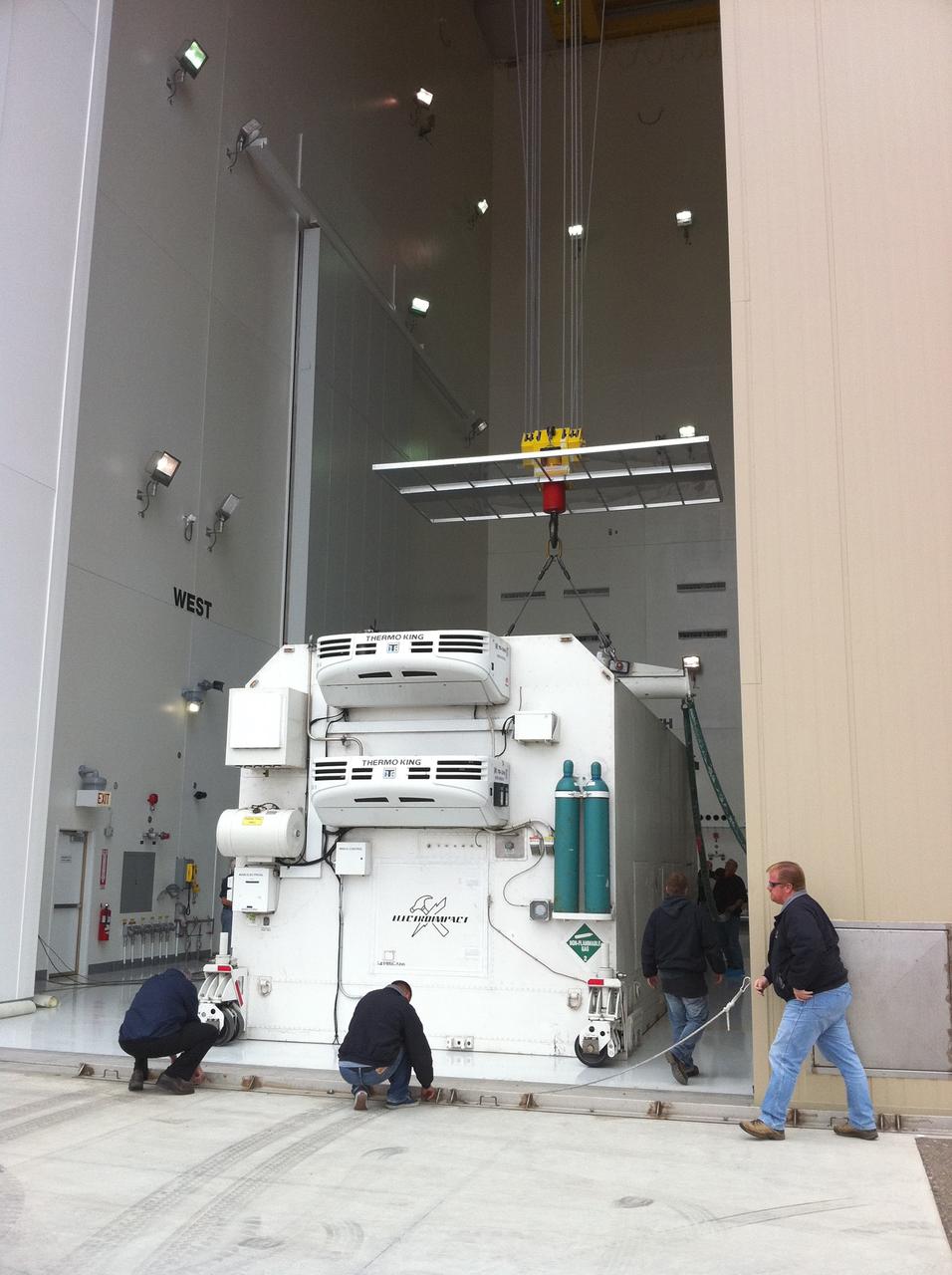 VANDENBERG AIR FORCE BASE, Calif. -- The environmentally controlled transportation container holding NASA's National Polar-orbiting Operational Environmental Satellite System Preparatory Project (NPP) satellite comes to rest on the floor of the Astrotech payload processing facility on Vandenberg Air Force Base in California.    NPP represents a critical first step in building the next-generation of Earth-observing satellites. NPP will carry the first of the new sensors developed for this satellite fleet, now known as the Joint Polar Satellite System (JPSS), to be launched in 2016. NPP is the bridge between NASA's Earth Observing System (EOS) satellites and the forthcoming series of JPSS satellites. The mission will test key technologies and instruments for the JPSS missions. NPP is targeted to launch Oct. 25 from Space Launch Complex-2 aboard a United Launch Alliance Delta II rocket. For more information, visit http://www.nasa.gov/NPP.    Photo credit: NASA/Jerry Nagy, VAFB