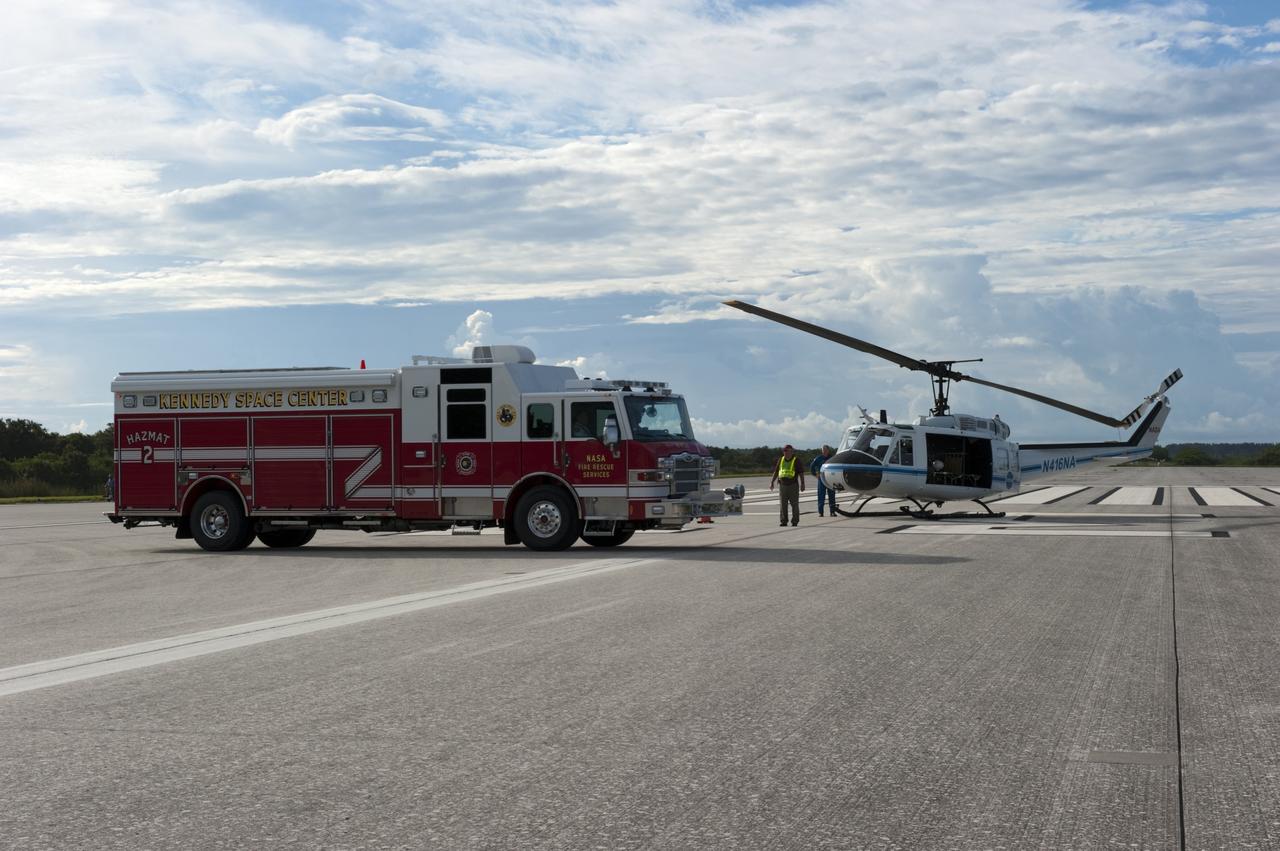 CAPE CANAVERAL, Fla. -- A NASA Fire Rescue Services vehicle and a Huey II helicopter support the aviation safety exercise during Emergency Response Safety Training at the Shuttle Landing Facility, Runway 33, at NASA’s Kennedy Space Center in Florida.    The simulated helicopter mishap exercise was conducted to evaluate emergency response and mishap investigations of aircraft at Kennedy. Participants included Air Rescue Fire Fighters, Flight Operations, Disaster Preparedness, Security, and Safety. NASA mandates simulated aviation safety training take place every two years. Photo credit: NASA/Kim Shiflett