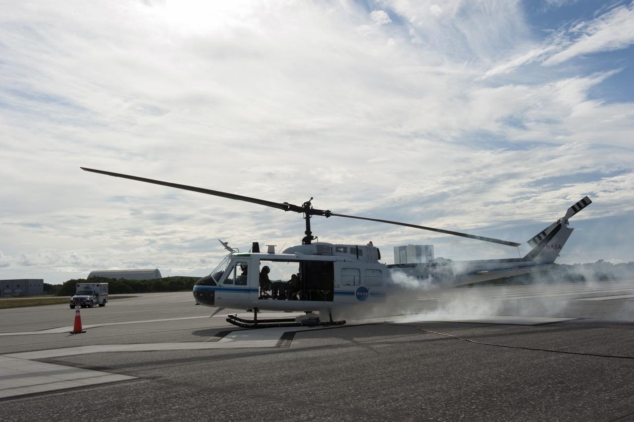 CAPE CANAVERAL, Fla. -- Smoke billows from a Huey II helicopter supporting the aviation safety exercise during Emergency Response Safety Training at the Shuttle Landing Facility, Runway 33, at NASA’s Kennedy Space Center in Florida.    The simulated helicopter mishap exercise was conducted to evaluate emergency response and mishap investigations of aircraft at Kennedy. Participants included Air Rescue Fire Fighters, Flight Operations, Disaster Preparedness, Security, and Safety. NASA mandates simulated aviation safety training take place every two years. Photo credit: NASA/Kim Shiflett