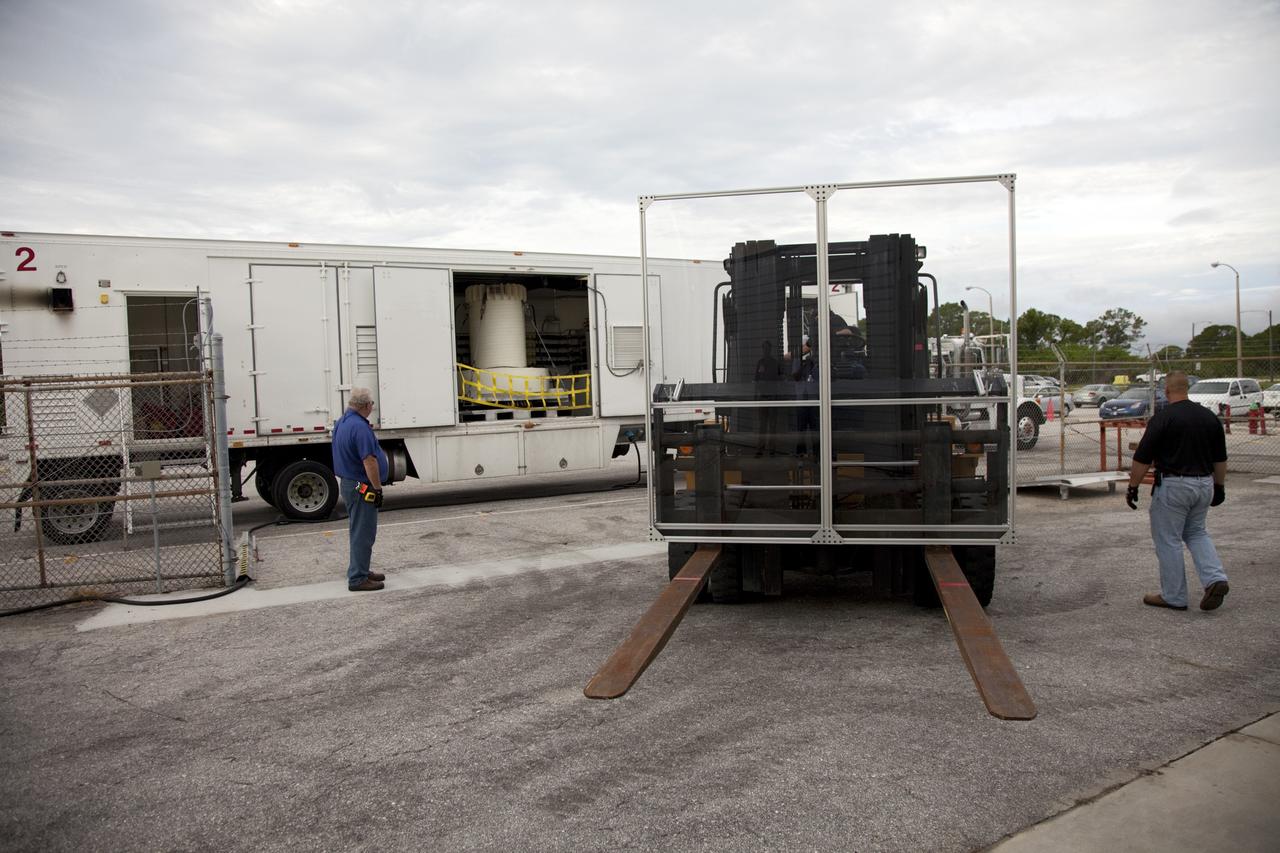 CAPE CANAVERAL, Fla. -- The multi-mission radioisotope thermoelectric generator (MMRTG) for NASA's Mars Science Laboratory mission, enclosed in a shipping cask, is seen through the open door of the MMRTG trailer that delivered it to the RTG storage facility at NASA's Kennedy Space Center in Florida.    The MMRTG will generate the power needed for the mission from the natural decay of plutonium-238, a non-weapons-grade form of the radioisotope. Heat given off by this natural decay will provide constant power through the day and night during all seasons.     Waste heat from the MMRTG will be circulated throughout the rover system to keep instruments, computers, mechanical devices and communications systems within their operating temperature ranges.     MSL's components include a compact car-sized rover, Curiosity, which has 10 science instruments designed to search for evidence on whether Mars has had environments favorable to microbial life, including chemical ingredients for life.  The unique rover will use a laser to look inside rocks and release its gasses so that the rover’s spectrometer can analyze and send the data back to Earth. Launch of MSL aboard a United Launch Alliance Atlas V rocket is scheduled for Nov. 25 from Space Launch Complex 41 on Cape Canaveral Air Force Station in Florida. For more information, visit http://www.nasa.gov/msl. Photo credit: NASA/Frankie Martin
