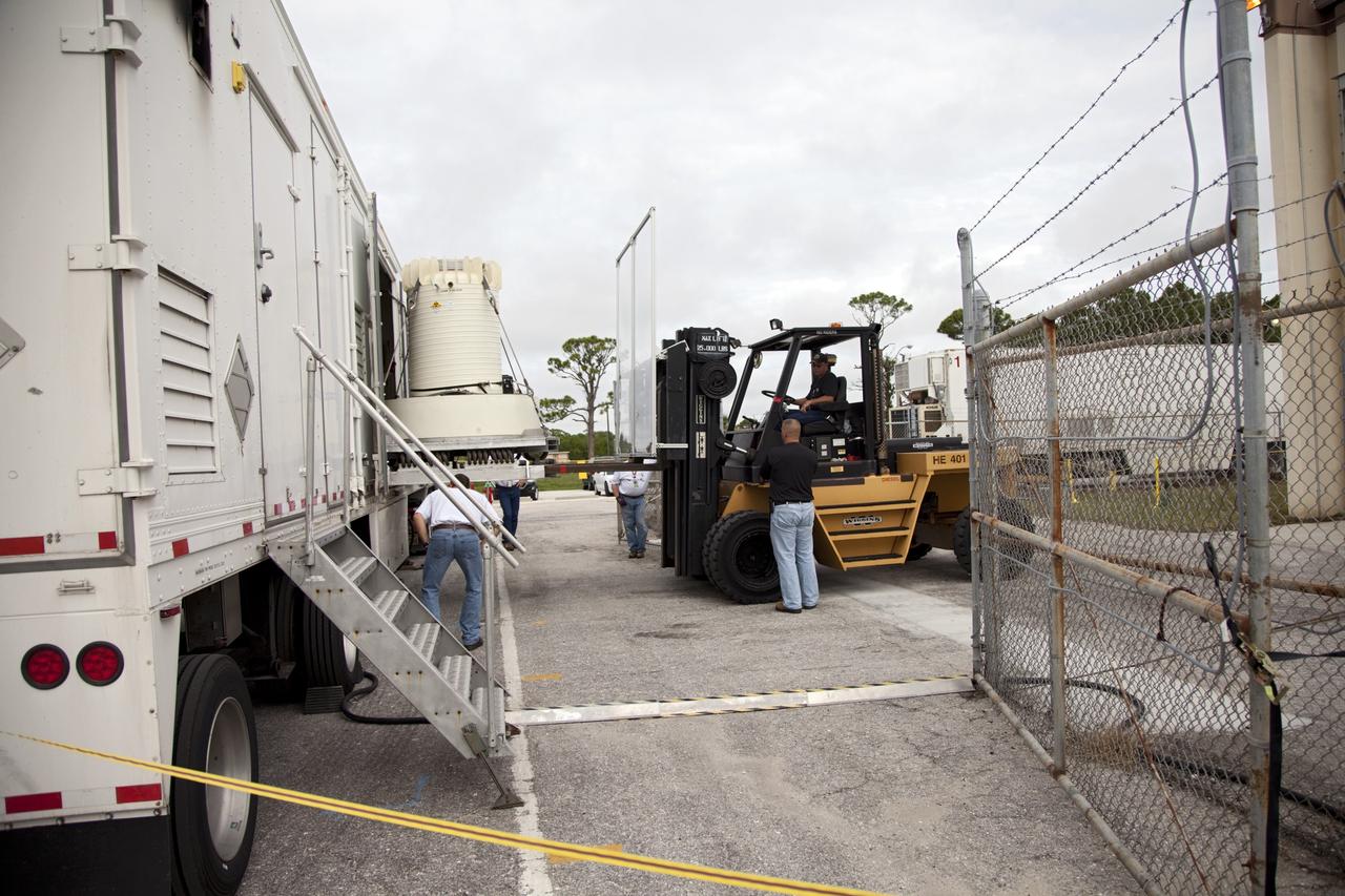 CAPE CANAVERAL, Fla. -- Workers use a forklift to offload the shipping cask enclosing the multi-mission radioisotope thermoelectric generator (MMRTG) for NASA's Mars Science Laboratory mission from the MMRTG trailer that delivered it to the RTG storage facility at NASA's Kennedy Space Center in Florida.      The MMRTG will generate the power needed for the mission from the natural decay of plutonium-238, a non-weapons-grade form of the radioisotope. Heat given off by this natural decay will provide constant power through the day and night during all seasons.       Waste heat from the MMRTG will be circulated throughout the rover system to keep instruments, computers, mechanical devices and communications systems within their operating temperature ranges.     MSL's components include a compact car-sized rover, Curiosity, which has 10 science instruments designed to search for evidence on whether Mars has had environments favorable to microbial life, including chemical ingredients for life.  The unique rover will use a laser to look inside rocks and release its gasses so that the rover’s spectrometer can analyze and send the data back to Earth. Launch of MSL aboard a United Launch Alliance Atlas V rocket is scheduled for Nov. 25 from Space Launch Complex 41 on Cape Canaveral Air Force Station in Florida. For more information, visit http://www.nasa.gov/msl. Photo credit: NASA/Frankie Martin