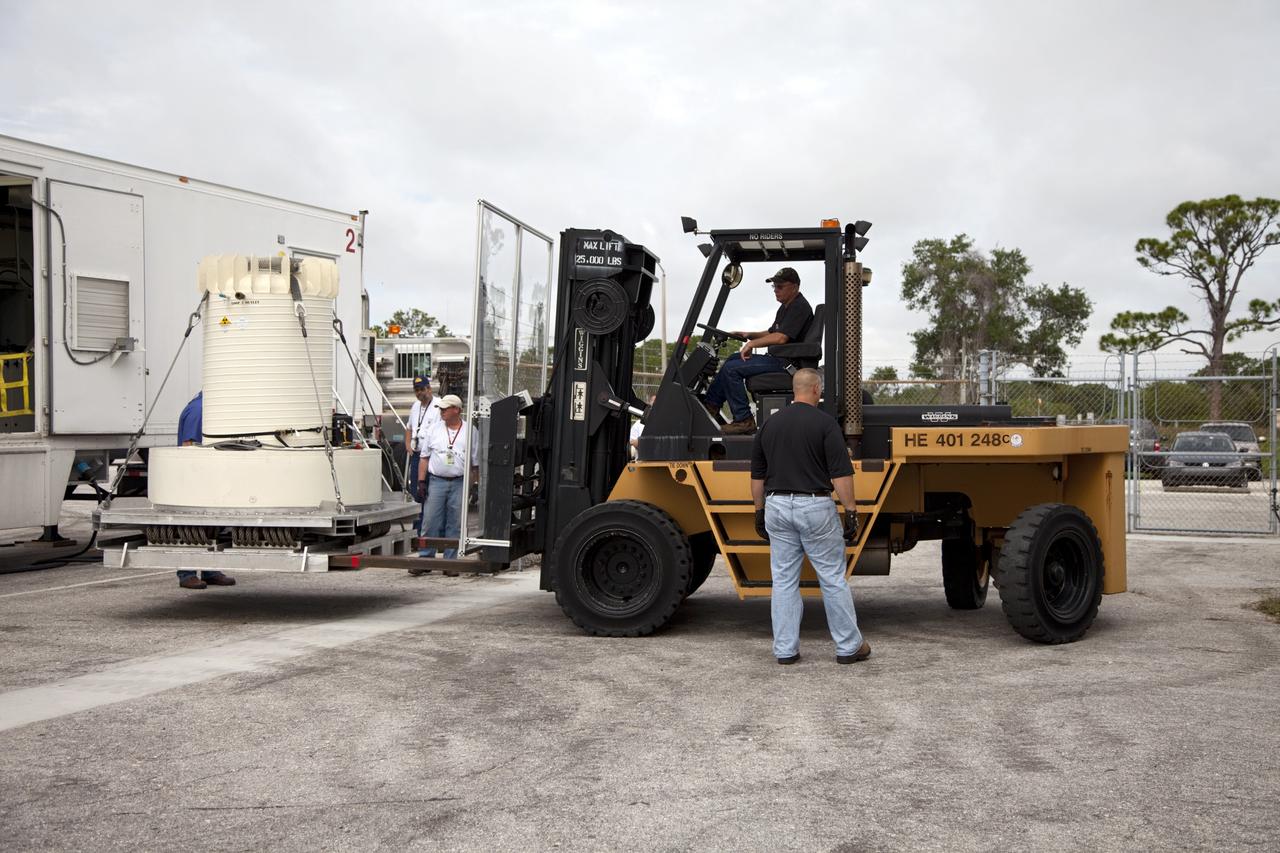 CAPE CANAVERAL, Fla. -- Workers use a forklift to offload the shipping cask enclosing the multi-mission radioisotope thermoelectric generator (MMRTG) for NASA's Mars Science Laboratory mission from the MMRTG trailer that delivered it to the RTG storage facility at NASA's Kennedy Space Center in Florida.      The MMRTG will generate the power needed for the mission from the natural decay of plutonium-238, a non-weapons-grade form of the radioisotope. Heat given off by this natural decay will provide constant power through the day and night during all seasons.     Waste heat from the MMRTG will be circulated throughout the rover system to keep instruments, computers, mechanical devices and communications systems within their operating temperature ranges.     MSL's components include a compact car-sized rover, Curiosity, which has 10 science instruments designed to search for evidence on whether Mars has had environments favorable to microbial life, including chemical ingredients for life.  The unique rover will use a laser to look inside rocks and release its gasses so that the rover’s spectrometer can analyze and send the data back to Earth. Launch of MSL aboard a United Launch Alliance Atlas V rocket is scheduled for Nov. 25 from Space Launch Complex 41 on Cape Canaveral Air Force Station in Florida. For more information, visit http://www.nasa.gov/msl. Photo credit: NASA/Frankie Martin