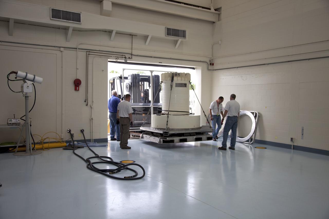 CAPE CANAVERAL, Fla. -- The multi-mission radioisotope thermoelectric generator (MMRTG) for NASA's Mars Science Laboratory mission, enclosed in a shipping cask, rolls into the high bay of the RTG storage facility at NASA's Kennedy Space Center in Florida.    The MMRTG will generate the power needed for the mission from the natural decay of plutonium-238, a non-weapons-grade form of the radioisotope. Heat given off by this natural decay will provide constant power through the day and night during all seasons.     Waste heat from the MMRTG will be circulated throughout the rover system to keep instruments, computers, mechanical devices and communications systems within their operating temperature ranges.    MSL's components include a compact car-sized rover, Curiosity, which has 10 science instruments designed to search for evidence on whether Mars has had environments favorable to microbial life, including chemical ingredients for life.  The unique rover will use a laser to look inside rocks and release its gasses so that the rover’s spectrometer can analyze and send the data back to Earth. Launch of MSL aboard a United Launch Alliance Atlas V rocket is scheduled for Nov. 25 from Space Launch Complex 41 on Cape Canaveral Air Force Station in Florida. For more information, visit http://www.nasa.gov/msl. Photo credit: NASA/Frankie Martin