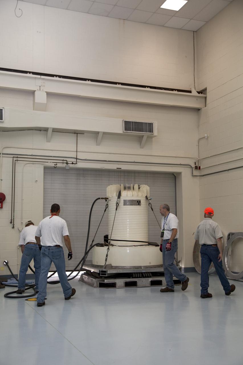 CAPE CANAVERAL, Fla. -- Workers reconnect the coolant hoses to the shipping cask enclosing the multi-mission radioisotope thermoelectric generator (MMRTG) for NASA's Mars Science Laboratory mission upon its arrival in the high bay of the RTG storage facility at NASA's Kennedy Space Center in Florida. Coolant flows through the hoses to dissipate any excess heat generated by the MMRTG. The MMRTG will generate the power needed for the mission from the natural decay of plutonium-238, a non-weapons-grade form of the radioisotope. Heat given off by this natural decay will provide constant power through the day and night during all seasons. Waste heat from the MMRTG will be circulated throughout the rover system to keep instruments, computers, mechanical devices and communications systems within their operating temperature ranges. MSL's components include a compact car-sized rover, Curiosity, which has 10 science instruments designed to search for evidence on whether Mars has had environments favorable to microbial life, including chemical ingredients for life. The unique rover will use a laser to look inside rocks and release its gasses so that the rover’s spectrometer can analyze and send the data back to Earth. Launch of MSL aboard a United Launch Alliance Atlas V rocket is scheduled for Nov. 25 from Space Launch Complex 41 on Cape Canaveral Air Force Station in Florida. For more information, visit http://www.nasa.gov/msl. Photo credit: NASA/Frankie Martin