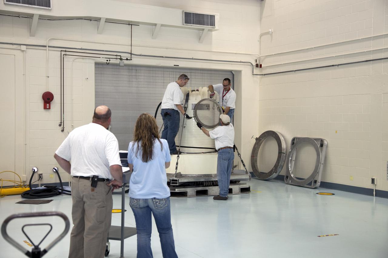 CAPE CANAVERAL, Fla. -- In the high bay of the RTG storage facility at NASA's Kennedy Space Center in Florida, preparations are under way to attach the shipping cask enclosing the multi-mission radioisotope thermoelectric generator (MMRTG) for NASA's Mars Science Laboratory mission to the cables that will lift it from its transportation pallet. The MMRTG will generate the power needed for the mission from the natural decay of plutonium-238, a non-weapons-grade form of the radioisotope. Heat given off by this natural decay will provide constant power through the day and night during all seasons. Waste heat from the MMRTG will be circulated throughout the rover system to keep instruments, computers, mechanical devices and communications systems within their operating temperature ranges. MSL's components include a compact car-sized rover, Curiosity, which has 10 science instruments designed to search for evidence on whether Mars has had environments favorable to microbial life, including chemical ingredients for life. The unique rover will use a laser to look inside rocks and release its gasses so that the rover’s spectrometer can analyze and send the data back to Earth. Launch of MSL aboard a United Launch Alliance Atlas V rocket is scheduled for Nov. 25 from Space Launch Complex 41 on Cape Canaveral Air Force Station in Florida. For more information, visit http://www.nasa.gov/msl. Photo credit: NASA/Frankie Martin