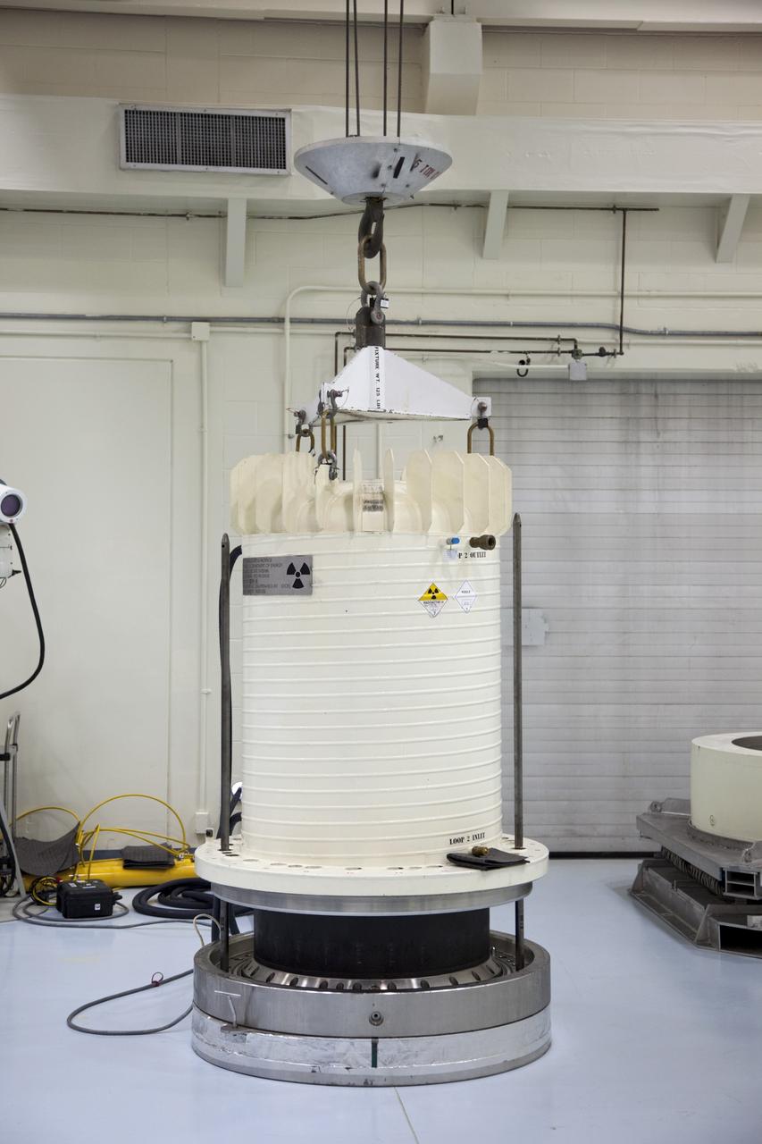 CAPE CANAVERAL, Fla. -- In the high bay of the RTG storage facility at NASA's Kennedy Space Center in Florida, the shipping cask enclosing the multi-mission radioisotope thermoelectric generator (MMRTG) for NASA's Mars Science Laboratory mission is lifted from around the MMRTG using guide rods installed on the support base. The MMRTG will generate the power needed for the mission from the natural decay of plutonium-238, a non-weapons-grade form of the radioisotope. Heat given off by this natural decay will provide constant power through the day and night during all seasons. Waste heat from the MMRTG will be circulated throughout the rover system to keep instruments, computers, mechanical devices and communications systems within their operating temperature ranges. MSL's components include a compact car-sized rover, Curiosity, which has 10 science instruments designed to search for evidence on whether Mars has had environments favorable to microbial life, including chemical ingredients for life. The unique rover will use a laser to look inside rocks and release its gasses so that the rover’s spectrometer can analyze and send the data back to Earth. Launch of MSL aboard a United Launch Alliance Atlas V rocket is scheduled for Nov. 25 from Space Launch Complex 41 on Cape Canaveral Air Force Station in Florida. For more information, visit http://www.nasa.gov/msl. Photo credit: NASA/Frankie Martin