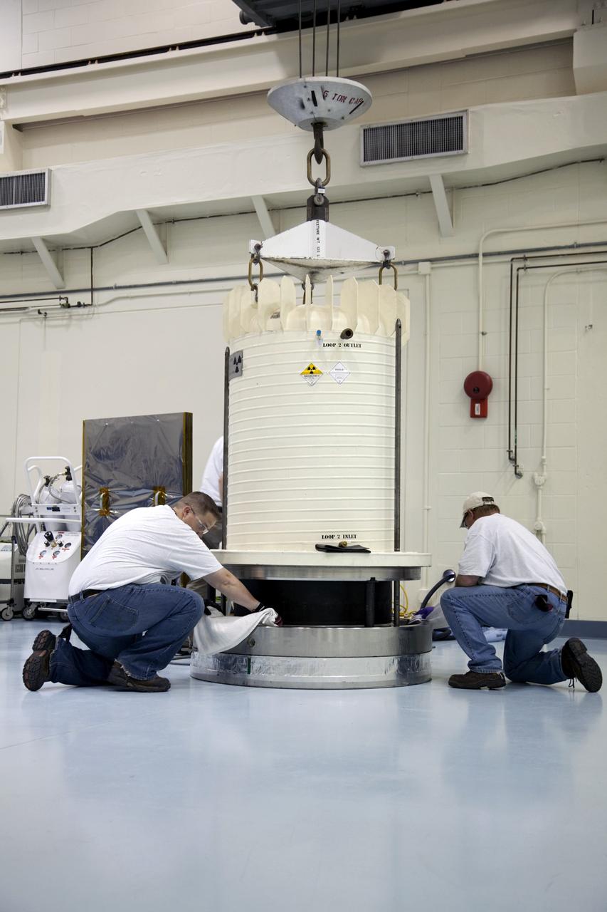 CAPE CANAVERAL, Fla. -- In the high bay of the RTG storage facility at NASA's Kennedy Space Center in Florida, Department of Energy contractor employees remove the external and internal protective layers of the shipping cask enclosing the multi-mission radioisotope thermoelectric generator (MMRTG) for NASA's Mars Science Laboratory mission. The MMRTG will generate the power needed for the mission from the natural decay of plutonium-238, a non-weapons-grade form of the radioisotope. Heat given off by this natural decay will provide constant power through the day and night during all seasons. Waste heat from the MMRTG will be circulated throughout the rover system to keep instruments, computers, mechanical devices and communications systems within their operating temperature ranges. MSL's components include a compact car-sized rover, Curiosity, which has 10 science instruments designed to search for evidence on whether Mars has had environments favorable to microbial life, including chemical ingredients for life. The unique rover will use a laser to look inside rocks and release its gasses so that the rover’s spectrometer can analyze and send the data back to Earth. Launch of MSL aboard a United Launch Alliance Atlas V rocket is scheduled for Nov. 25 from Space Launch Complex 41 on Cape Canaveral Air Force Station in Florida. For more information, visit http://www.nasa.gov/msl. Photo credit: NASA/Frankie Martin