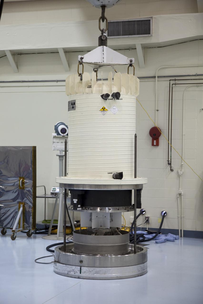 CAPE CANAVERAL, Fla. -- In the high bay of the RTG storage facility at NASA's Kennedy Space Center in Florida, the external and internal protective layers  of the shipping cask are lifted from around the multi-mission radioisotope thermoelectric generator (MMRTG) for NASA's Mars Science Laboratory mission.    The MMRTG will generate the power needed for the mission from the natural decay of plutonium-238, a non-weapons-grade form of the radioisotope. Heat given off by this natural decay will provide constant power through the day and night during all seasons.    Waste heat from the MMRTG will be circulated throughout the rover system to keep instruments, computers, mechanical devices and communications systems within their operating temperature ranges.    MSL's components include a compact car-sized rover, Curiosity, which has 10 science instruments designed to search for evidence on whether Mars has had environments favorable to microbial life, including chemical ingredients for life.  The unique rover will use a laser to look inside rocks and release its gasses so that the rover’s spectrometer can analyze and send the data back to Earth. Launch of MSL aboard a United Launch Alliance Atlas V rocket is scheduled for Nov. 25 from Space Launch Complex 41 on Cape Canaveral Air Force Station in Florida. For more information, visit http://www.nasa.gov/msl. Photo credit: NASA/Frankie Martin
