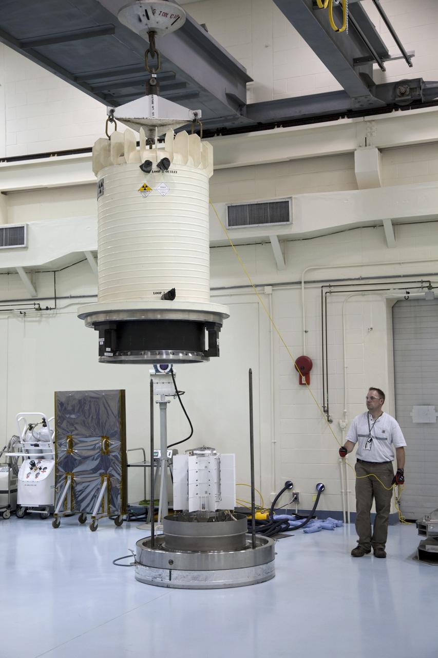 CAPE CANAVERAL, Fla. -- In the high bay of the RTG storage facility at NASA's Kennedy Space Center in Florida, the external and internal protective layers of the shipping cask are lifted away from the multi-mission radioisotope thermoelectric generator (MMRTG) for NASA's Mars Science Laboratory mission. The MMRTG no longer needs supplemental cooling since any excess heat generated can dissipate into the air in the high bay. The MMRTG will generate the power needed for the mission from the natural decay of plutonium-238, a non-weapons-grade form of the radioisotope. Heat given off by this natural decay will provide constant power through the day and night during all seasons. Waste heat from the MMRTG will be circulated throughout the rover system to keep instruments, computers, mechanical devices and communications systems within their operating temperature ranges. MSL's components include a compact car-sized rover, Curiosity, which has 10 science instruments designed to search for evidence on whether Mars has had environments favorable to microbial life, including chemical ingredients for life. The unique rover will use a laser to look inside rocks and release its gasses so that the rover’s spectrometer can analyze and send the data back to Earth. Launch of MSL aboard a United Launch Alliance Atlas V rocket is scheduled for Nov. 25 from Space Launch Complex 41 on Cape Canaveral Air Force Station in Florida. For more information, visit http://www.nasa.gov/msl. Photo credit: NASA/Frankie Martin