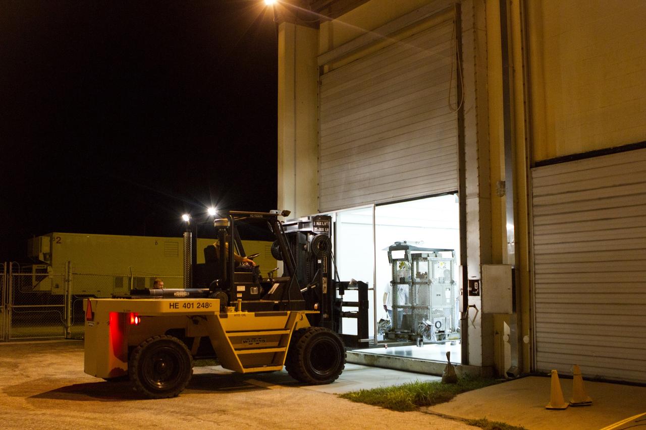 CAPE CANAVERAL, Fla. -- Outside the high bay of the RTG storage facility at NASA's Kennedy Space Center in Florida, a forklift picks up the protective mesh container, known as the "gorilla cage," enclosing the multi-mission radioisotope thermoelectric generator (MMRTG) for NASA's Mars Science Laboratory (MSL) mission for its move to the Payload Hazardous Servicing Facility (PHSF). The cage protects the MMRTG and allows any excess heat generated to dissipate into the air. In the PHSF, the MMRTG temporarily will be installed on the MSL rover, Curiosity, for a fit check but will be installed on the rover for launch at the pad. The MMRTG will generate the power needed for the mission from the natural decay of plutonium-238, a non-weapons-grade form of the radioisotope. Heat given off by this natural decay will provide constant power through the day and night during all seasons. Curiosity, MSL's car-sized rover, has 10 science instruments designed to search for signs of life, including methane, and help determine if the gas is from a biological or geological source. Waste heat from the MMRTG will be circulated throughout the rover system to keep instruments, computers, mechanical devices and communications systems within their operating temperature ranges. Launch of MSL aboard a United Launch Alliance Atlas V rocket is planned for Nov. 25 from Space Launch Complex 41 on Cape Canaveral Air Force Station. For more information, visit http://www.nasa.gov/msl. Photo credit: NASA/Cory Huston