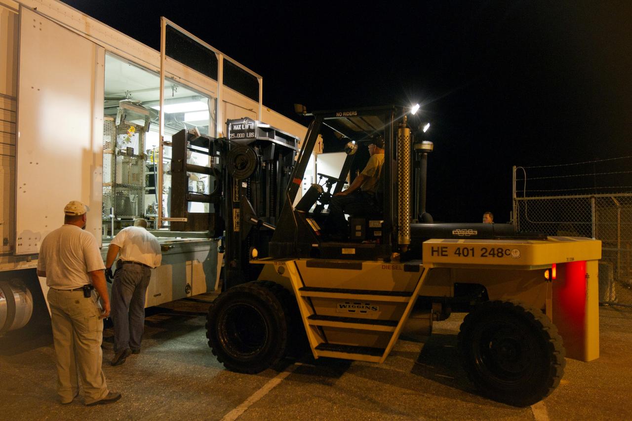 CAPE CANAVERAL, Fla. -- Outside the RTG storage facility at NASA's Kennedy Space Center in Florida, a forklift positions the protective mesh container, known as the "gorilla cage," enclosing the multi-mission radioisotope thermoelectric generator (MMRTG) for NASA's Mars Science Laboratory (MSL) mission inside the MMRTG trailer that will transport it to the Payload Hazardous Servicing Facility (PHSF). The cage protects the MMRTG and allows any excess heat generated to dissipate into the air. In the PHSF, the MMRTG temporarily will be installed on the MSL rover, Curiosity, for a fit check but will be installed on the rover for launch at the pad. The MMRTG will generate the power needed for the mission from the natural decay of plutonium-238, a non-weapons-grade form of the radioisotope. Heat given off by this natural decay will provide constant power through the day and night during all seasons. Curiosity, MSL's car-sized rover, has 10 science instruments designed to search for signs of life, including methane, and help determine if the gas is from a biological or geological source. Waste heat from the MMRTG will be circulated throughout the rover system to keep instruments, computers, mechanical devices and communications systems within their operating temperature ranges. Launch of MSL aboard a United Launch Alliance Atlas V rocket is planned for Nov. 25 from Space Launch Complex 41 on Cape Canaveral Air Force Station. For more information, visit http://www.nasa.gov/msl. Photo credit: NASA/Cory Huston