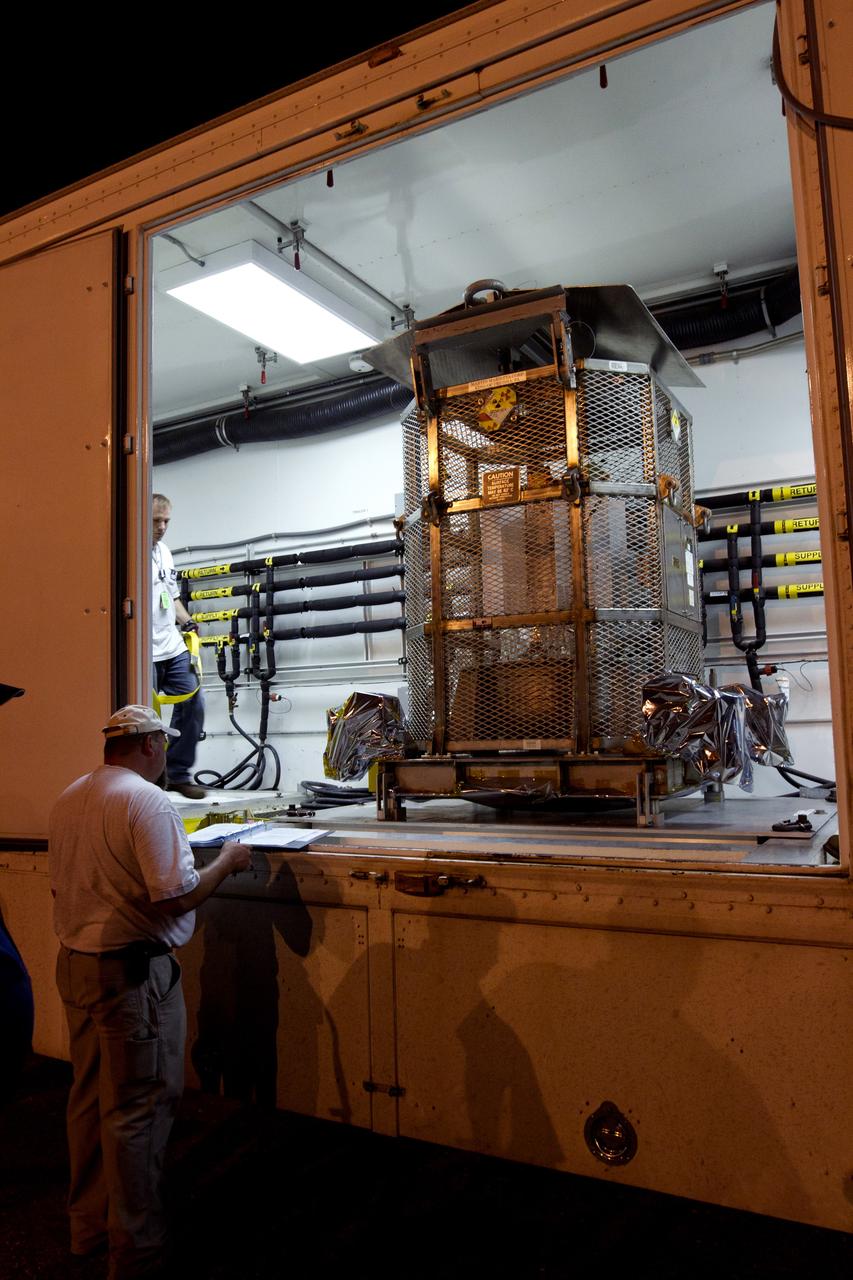 CAPE CANAVERAL, Fla. -- Outside the RTG storage facility at NASA's Kennedy Space Center in Florida, the multi-mission radioisotope thermoelectric generator (MMRTG) for NASA's Mars Science Laboratory (MSL) mission, enclosed in the protective mesh container, known as the "gorilla cage," is positioned inside the MMRTG trailer that will transport it to the Payload Hazardous Servicing Facility (PHSF).  The cage protects the MMRTG and allows any excess heat generated to dissipate into the air.  In the PHSF, the MMRTG temporarily will be installed on the MSL rover, Curiosity, for a fit check but will be installed on the rover for launch at the pad.    The MMRTG will generate the power needed for the mission from the natural decay of plutonium-238, a non-weapons-grade form of the radioisotope. Heat given off by this natural decay will provide constant power through the day and night during all seasons. Curiosity, MSL's car-sized rover, has 10 science instruments designed to search for signs of life, including methane, and help determine if the gas is from a biological or geological source. Waste heat from the MMRTG will be circulated throughout the rover system to keep instruments, computers, mechanical devices and communications systems within their operating temperature ranges. Launch of MSL aboard a United Launch Alliance Atlas V rocket is planned for Nov. 25 from Space Launch Complex 41 on Cape Canaveral Air Force Station. For more information, visit http://www.nasa.gov/msl. Photo credit: NASA/Cory Huston