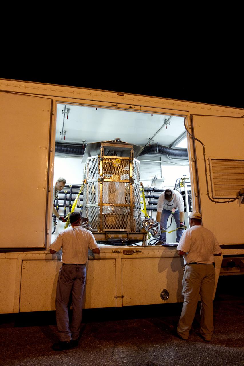 CAPE CANAVERAL, Fla. -- Outside the RTG storage facility at NASA's Kennedy Space Center in Florida, the multi-mission radioisotope thermoelectric generator (MMRTG) for NASA's Mars Science Laboratory (MSL) mission, enclosed in the protective mesh container known as the "gorilla cage," is strapped down inside the MMRTG trailer for transport to the Payload Hazardous Servicing Facility (PHSF).  The cage protects the MMRTG and allows any excess heat generated to dissipate into the air.  In the PHSF, the MMRTG temporarily will be installed on the MSL rover, Curiosity, for a fit check but will be installed on the rover for launch at the pad.    The MMRTG will generate the power needed for the mission from the natural decay of plutonium-238, a non-weapons-grade form of the radioisotope. Heat given off by this natural decay will provide constant power through the day and night during all seasons. Curiosity, MSL's car-sized rover, has 10 science instruments designed to search for signs of life, including methane, and help determine if the gas is from a biological or geological source. Waste heat from the MMRTG will be circulated throughout the rover system to keep instruments, computers, mechanical devices and communications systems within their operating temperature ranges. Launch of MSL aboard a United Launch Alliance Atlas V rocket is planned for Nov. 25 from Space Launch Complex 41 on Cape Canaveral Air Force Station. For more information, visit http://www.nasa.gov/msl. Photo credit: NASA/Cory Huston