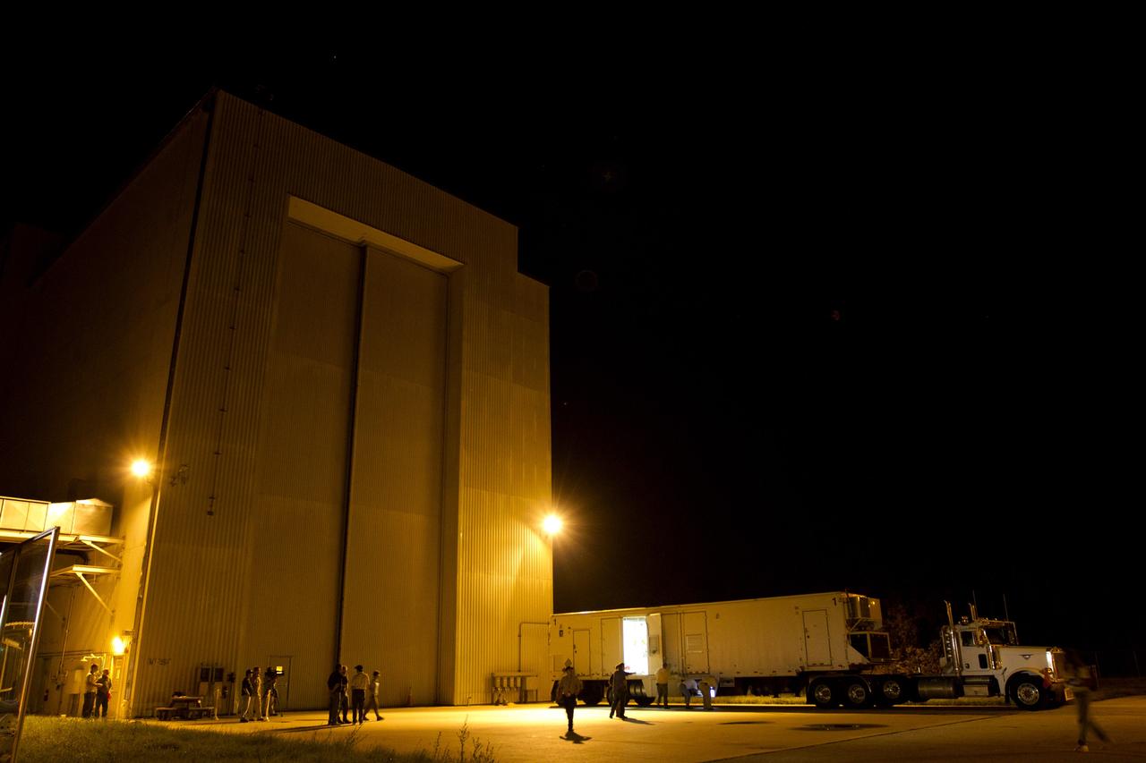 CAPE CANAVERAL, Fla. -- The multi-mission radioisotope thermoelectric generator (MMRTG) trailer backs toward the airlock doors of the Payload Hazardous Servicing Facility (PHSF) at NASA's Kennedy Space Center in Florida. The MMRTG for NASA's Mars Science Laboratory (MSL) mission is being transferred into the PHSF, where it will be installed on the MSL rover, Curiosity, for a fit check. The MMRTG will be installed on the rover for launch at the pad.    The MMRTG will generate the power needed for the mission from the natural decay of plutonium-238, a non-weapons-grade form of the radioisotope. Heat given off by this natural decay will provide constant power through the day and night during all seasons. Curiosity, MSL's car-sized rover, has 10 science instruments designed to search for signs of life, including methane, and help determine if the gas is from a biological or geological source. Waste heat from the MMRTG will be circulated throughout the rover system to keep instruments, computers, mechanical devices and communications systems within their operating temperature ranges. Launch of MSL aboard a United Launch Alliance Atlas V rocket is planned for Nov. 25 from Space Launch Complex 41 on Cape Canaveral Air Force Station. For more information, visit http://www.nasa.gov/msl. Photo credit: NASA/Cory Huston
