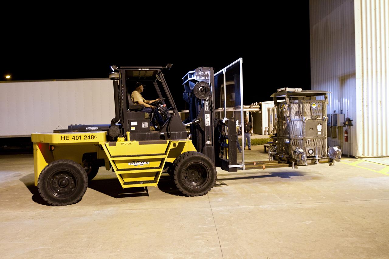 CAPE CANAVERAL, Fla. -- At NASA's Kennedy Space Center in Florida, a forklift carries the protective mesh container, known as the "gorilla cage," enclosing the multi-mission radioisotope thermoelectric generator (MMRTG) for NASA's Mars Science Laboratory (MSL) mission into the airlock of the Payload Hazardous Servicing Facility (PHSF).  The cage protects the MMRTG and allows any excess heat generated to dissipate into the air.  In the PHSF, the MMRTG temporarily will be installed on the MSL rover, Curiosity, for a fit check but will be installed on the rover for launch at the pad.    The MMRTG will generate the power needed for the mission from the natural decay of plutonium-238, a non-weapons-grade form of the radioisotope. Heat given off by this natural decay will provide constant power through the day and night during all seasons. Curiosity, MSL's car-sized rover, has 10 science instruments designed to search for signs of life, including methane, and help determine if the gas is from a biological or geological source. Waste heat from the MMRTG will be circulated throughout the rover system to keep instruments, computers, mechanical devices and communications systems within their operating temperature ranges. Launch of MSL aboard a United Launch Alliance Atlas V rocket is planned for Nov. 25 from Space Launch Complex 41 on Cape Canaveral Air Force Station. For more information, visit http://www.nasa.gov/msl. Photo credit: NASA/Cory Huston