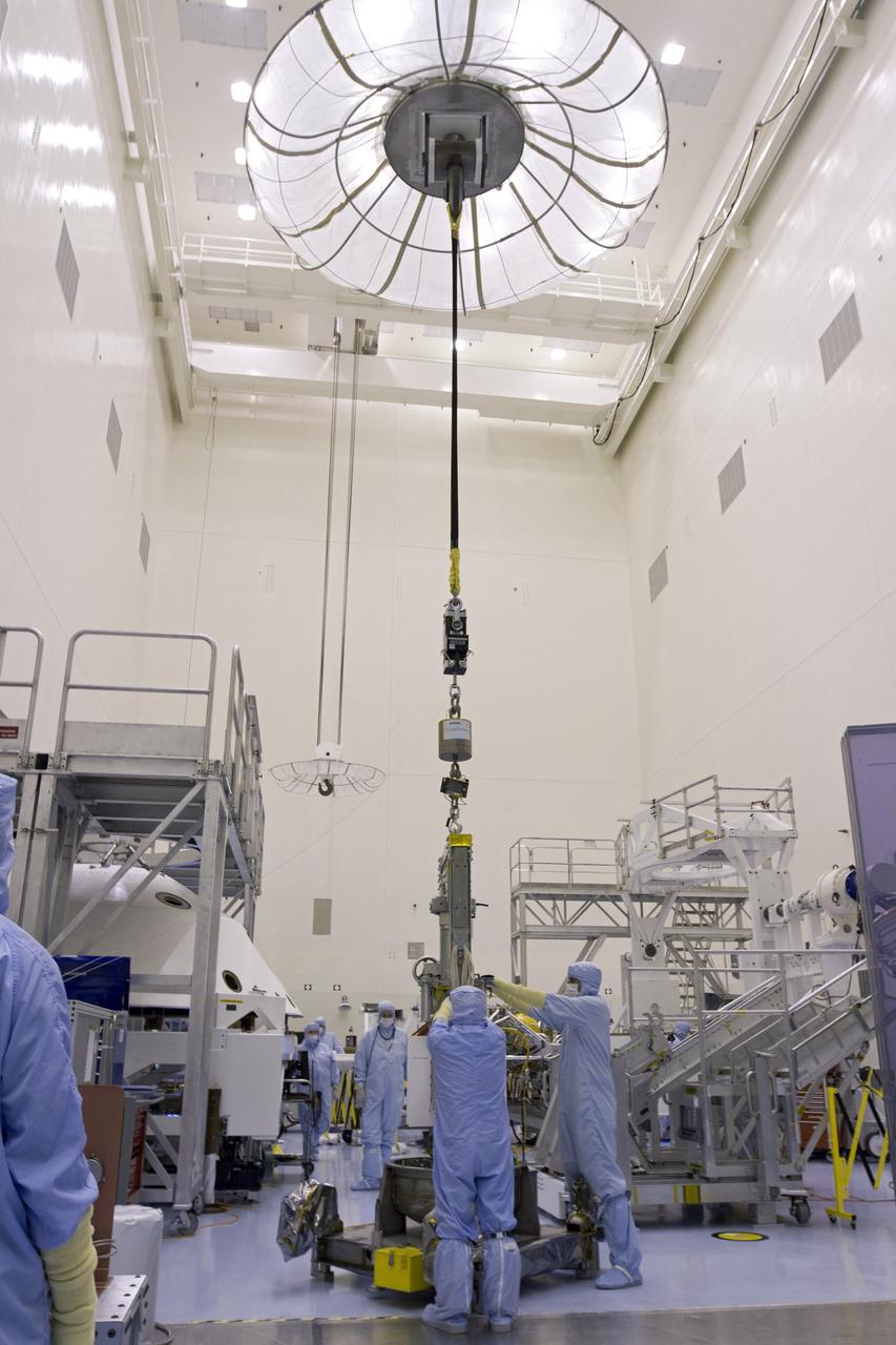 CAPE CANAVERAL, Fla. -- In the high bay of the Payload Hazardous Servicing Facility (PHSF) at NASA's Kennedy Space Center in Florida, spacecraft technicians from NASA's Jet Propulsion Laboratory connect a crane to a turning fixture connected to the multi-mission radioisotope thermoelectric generator (MMRTG) for NASA's Mars Science Laboratory (MSL) mission. The fixture will lift and lower the MMRTG onto the MMRTG integration cart. The cart will be used to install the MMRTG on Curiosity for a fit check. The MMRTG will be installed on the rover for launch at the pad.    The MMRTG will generate the power needed for the mission from the natural decay of plutonium-238, a non-weapons-grade form of the radioisotope. Heat given off by this natural decay will provide constant power through the day and night during all seasons. Curiosity, MSL's car-sized rover, has 10 science instruments designed to search for signs of life, including methane, and help determine if the gas is from a biological or geological source. Waste heat from the MMRTG will be circulated throughout the rover system to keep instruments, computers, mechanical devices and communications systems within their operating temperature ranges. Launch of MSL aboard a United Launch Alliance Atlas V rocket is planned for Nov. 25 from Space Launch Complex 41 on Cape Canaveral Air Force Station. For more information, visit http://www.nasa.gov/msl. Photo credit: NASA/Cory Huston