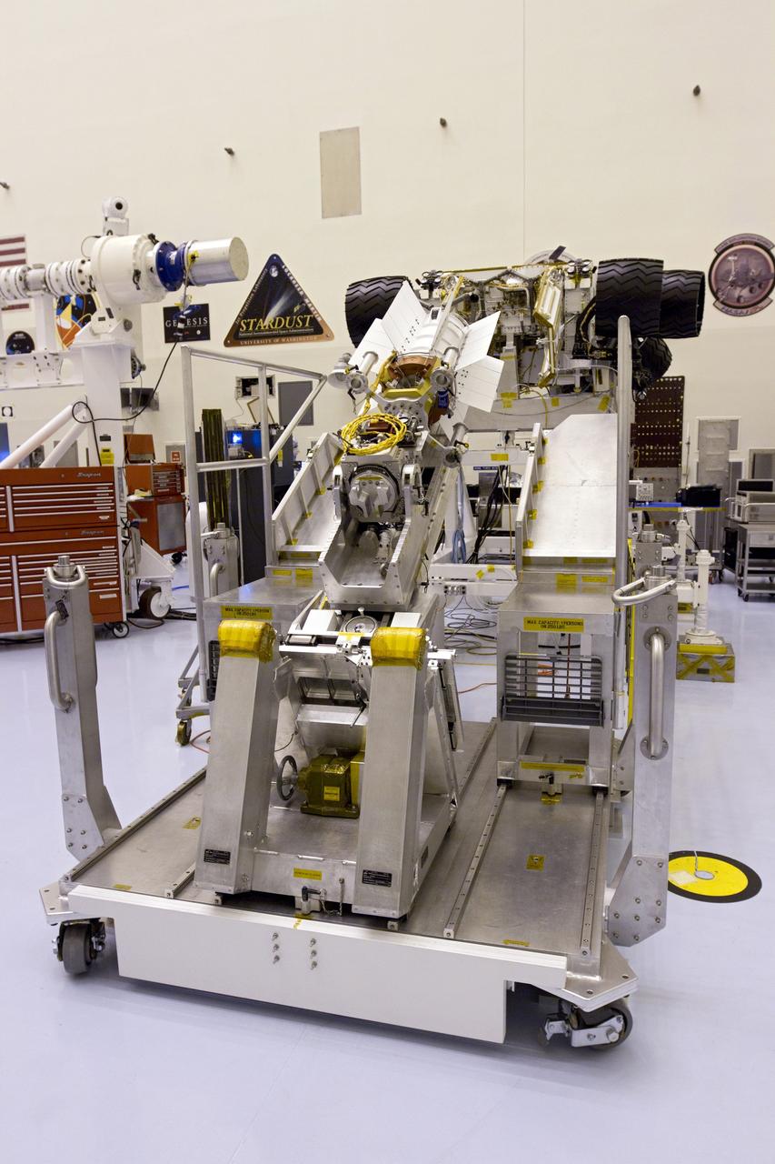 CAPE CANAVERAL, Fla. -- In the high bay of the Payload Hazardous Servicing Facility (PHSF) at NASA's Kennedy Space Center in Florida, the multi-mission radioisotope thermoelectric generator (MMRTG) for NASA's Mars Science Laboratory (MSL) mission is attached to the MMRTG integration cart. The cart will be used to install the MMRTG on the Curiosity rover for a fit check. The wheels of the rover appear to stick out on either side of the cart. The MMRTG will be installed on the rover for launch at the pad.    The MMRTG will generate the power needed for the mission from the natural decay of plutonium-238, a non-weapons-grade form of the radioisotope. Heat given off by this natural decay will provide constant power through the day and night during all seasons. Curiosity, MSL's car-sized rover, has 10 science instruments designed to search for signs of life, including methane, and help determine if the gas is from a biological or geological source. Waste heat from the MMRTG will be circulated throughout the rover system to keep instruments, computers, mechanical devices and communications systems within their operating temperature ranges. Launch of MSL aboard a United Launch Alliance Atlas V rocket is planned for Nov. 25 from Space Launch Complex 41 on Cape Canaveral Air Force Station. For more information, visit http://www.nasa.gov/msl. Photo credit: NASA/Cory Huston