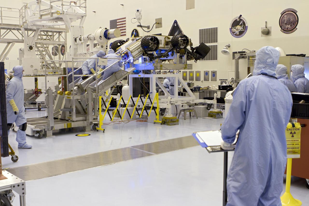 CAPE CANAVERAL, Fla. -- In the high bay of the Payload Hazardous Servicing Facility (PHSF) at NASA's Kennedy Space Center in Florida, spacecraft technicians from NASA's Jet Propulsion Laboratory transfer the multi-mission radioisotope thermoelectric generator (MMRTG) for NASA's Mars Science Laboratory (MSL) mission onto the aft of the Curiosity rover for a fit check with the aid of the MMRTG integration cart. The MMRTG then will be removed and installed on the rover for launch at the pad.    The MMRTG will generate the power needed for the mission from the natural decay of plutonium-238, a non-weapons-grade form of the radioisotope. Heat given off by this natural decay will provide constant power through the day and night during all seasons. Curiosity, MSL's car-sized rover, has 10 science instruments designed to search for signs of life, including methane, and help determine if the gas is from a biological or geological source. Waste heat from the MMRTG will be circulated throughout the rover system to keep instruments, computers, mechanical devices and communications systems within their operating temperature ranges. Launch of MSL aboard a United Launch Alliance Atlas V rocket is planned for Nov. 25 from Space Launch Complex 41 on Cape Canaveral Air Force Station. For more information, visit http://www.nasa.gov/msl. Photo credit: NASA/Cory Huston