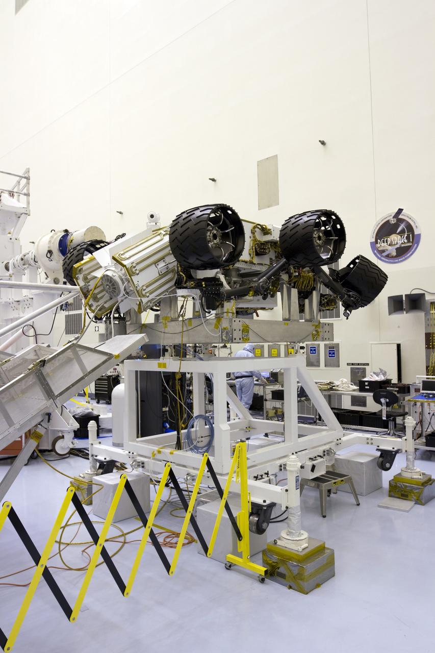 CAPE CANAVERAL, Fla. -- In the high bay of the Payload Hazardous Servicing Facility (PHSF) at NASA's Kennedy Space Center in Florida, the multi-mission radioisotope thermoelectric generator (MMRTG) for NASA's Mars Science Laboratory (MSL) mission is installed onto the aft of the Curiosity rover for a fit check. In view are the MMRTG's cooling fins which function like the radiator on a car and will reflect any excess heat generated by the MMRTG to prevent interference with the rover's electronics. Next, the MMRTG will be removed and later installed on the rover for launch at the pad. The MMRTG will generate the power needed for the mission from the natural decay of plutonium-238, a non-weapons-grade form of the radioisotope. Heat given off by this natural decay will provide constant power through the day and night during all seasons. Curiosity, MSL's car-sized rover, has 10 science instruments designed to search for signs of life, including methane, and help determine if the gas is from a biological or geological source. Waste heat from the MMRTG will be circulated throughout the rover system to keep instruments, computers, mechanical devices and communications systems within their operating temperature ranges. Launch of MSL aboard a United Launch Alliance Atlas V rocket is planned for Nov. 25 from Space Launch Complex 41 on Cape Canaveral Air Force Station. For more information, visit http://www.nasa.gov/msl. Photo credit: NASA/Cory Huston