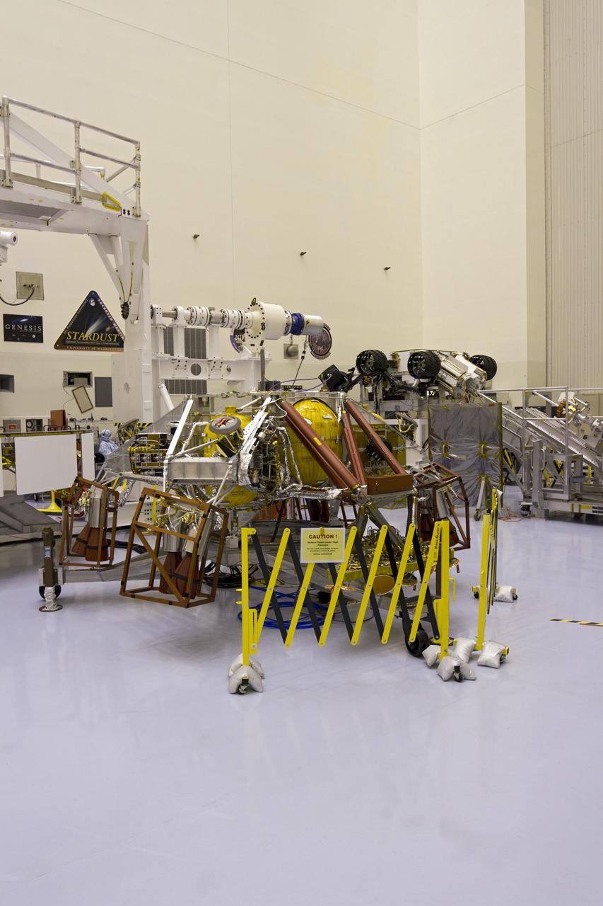 CAPE CANAVERAL, Fla. -- In the high bay of the Payload Hazardous Servicing Facility (PHSF) at NASA's Kennedy Space Center in Florida, the descent stage for NASA's Mars Science Laboratory (MSL) mission awaits installation on the Curiosity rover, in the background at right. MSL's multi-mission radioisotope thermoelectric generator has been installed onto the aft of the rover for a fit check.  The descent stage will cradle the rover and its MMRTG during their approach to the surface of Mars.     The MMRTG will generate the power needed for the mission from the natural decay of plutonium-238, a non-weapons-grade form of the radioisotope. Heat given off by this natural decay will provide constant power through the day and night during all seasons. Curiosity, MSL's car-sized rover, has 10 science instruments designed to search for signs of life, including methane, and help determine if the gas is from a biological or geological source. Waste heat from the MMRTG will be circulated throughout the rover system to keep instruments, computers, mechanical devices and communications systems within their operating temperature ranges. Launch of MSL aboard a United Launch Alliance Atlas V rocket is planned for Nov. 25 from Space Launch Complex 41 on Cape Canaveral Air Force Station. For more information, visit http://www.nasa.gov/msl. Photo credit: NASA/Cory Huston