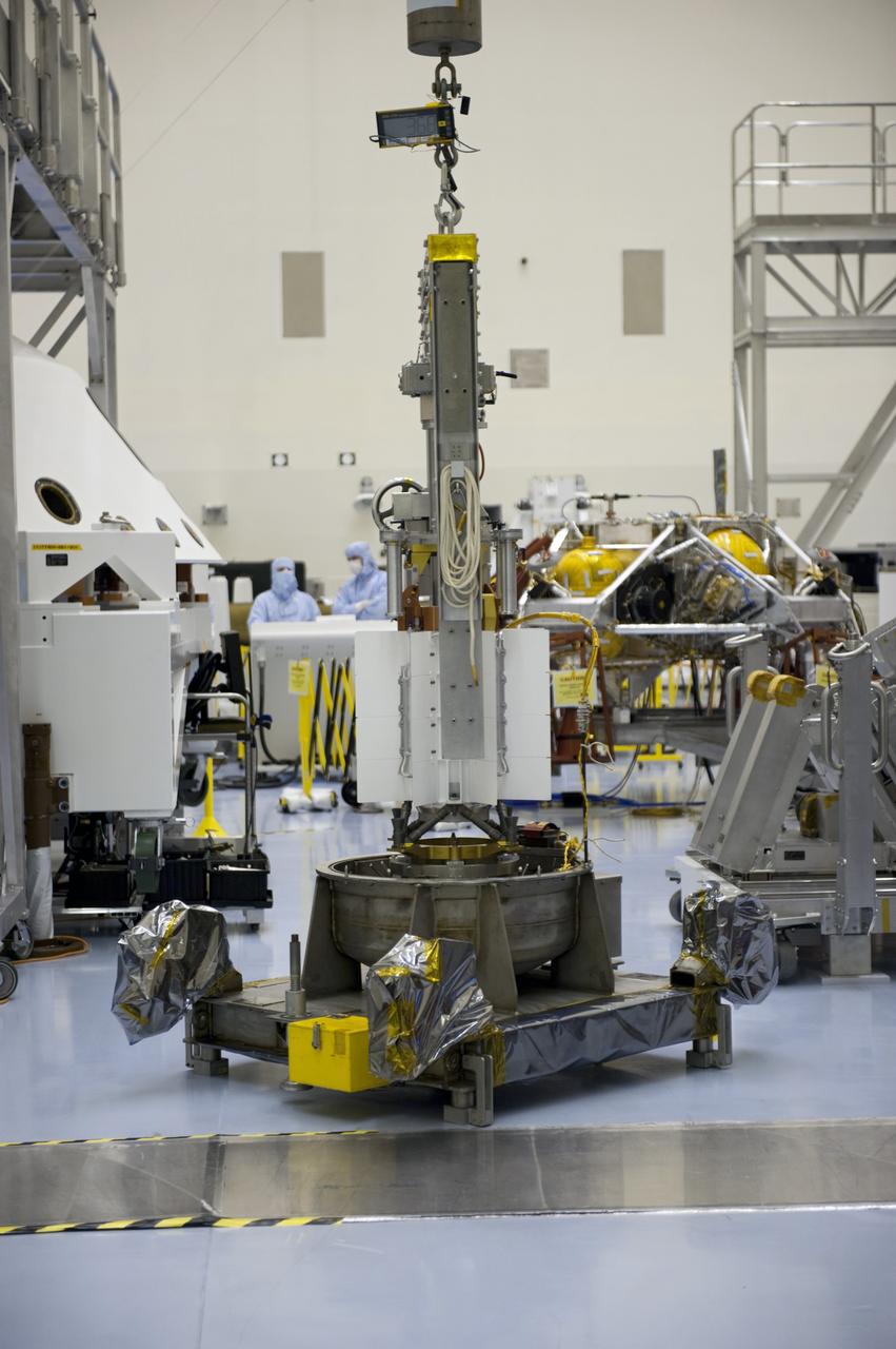CAPE CANAVERAL, Fla. -- In the high bay of the Payload Hazardous Servicing Facility at NASA's Kennedy Space Center in Florida, the multi-mission radioisotope thermoelectric generator (MMRTG) for NASA's Mars Science Laboratory (MSL) mission is positioned on a support base with the aid of a turning fixture following the MMRTG fit check on the Curiosity rover.    The MMRTG will generate the power needed for the mission from the natural decay of plutonium-238, a non-weapons-grade form of the radioisotope. Heat given off by this natural decay will provide constant power through the day and night during all seasons. MSL's components include a car-sized rover, Curiosity, which has 10 science instruments designed to search for signs of life, including methane, and help determine if the gas is from a biological or geological source. Waste heat from the MMRTG will be circulated throughout the rover system to keep instruments, computers, mechanical devices and communications systems within their operating temperature ranges. Launch of MSL aboard a United Launch Alliance Atlas V rocket is targeted for Nov. 25 from Space Launch Complex 41 on Cape Canaveral Air Force Station. For more information, visit http://www.nasa.gov/msl. Photo credit: NASA/Kim Shiflett