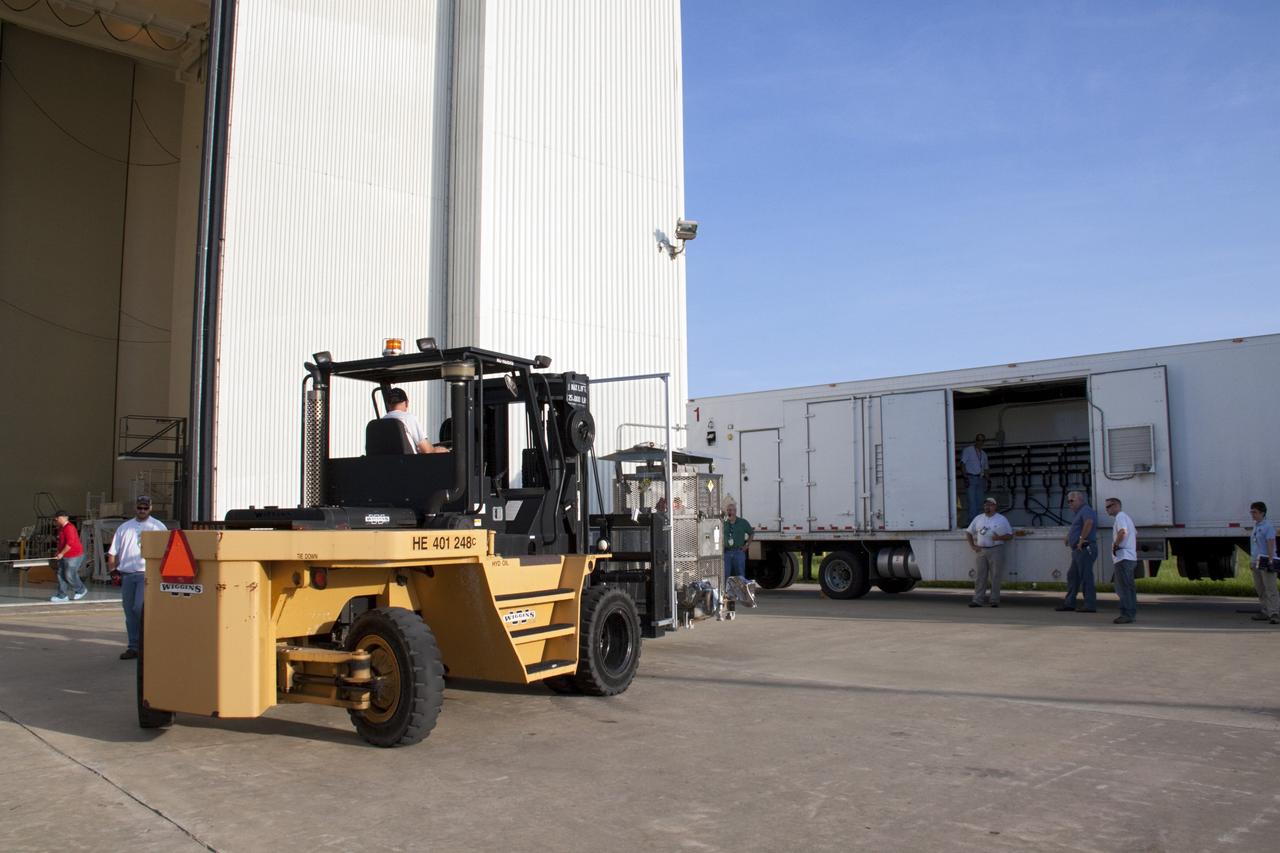CAPE CANAVERAL, Fla. -- A forklift transfers the multi-mission radioisotope thermoelectric generator (MMRTG) for NASA's Mars Science Laboratory (MSL) mission from the airlock of the Payload Hazardous Servicing Facility (PHSF) at NASA's Kennedy Space Center in Florida to the MMRTG trailer. The MMRTG is enclosed in a mesh container, known as the "gorilla cage," which protects it during transport and allows any excess heat generated to dissipate into the air.  The MMRTG is being moved to the RTG storage facility following a fit check on MSL's Curiosity rover in the PHSF.    The MMRTG will generate the power needed for the mission from the natural decay of plutonium-238, a non-weapons-grade form of the radioisotope. Heat given off by this natural decay will provide constant power through the day and night during all seasons. MSL's components include a compact car-sized rover, Curiosity, which has 10 science instruments designed to search for signs of life, including methane, and help determine if the gas is from a biological or geological source. Waste heat from the MMRTG will be circulated throughout the rover system to keep instruments, computers, mechanical devices and communications systems within their operating temperature ranges. Launch of MSL aboard a United Launch Alliance Atlas V rocket is targeted for Nov. 25 from Space Launch Complex 41 on Cape Canaveral Air Force Station. For more information, visit http://www.nasa.gov/msl. Photo credit: NASA/Troy Cryder