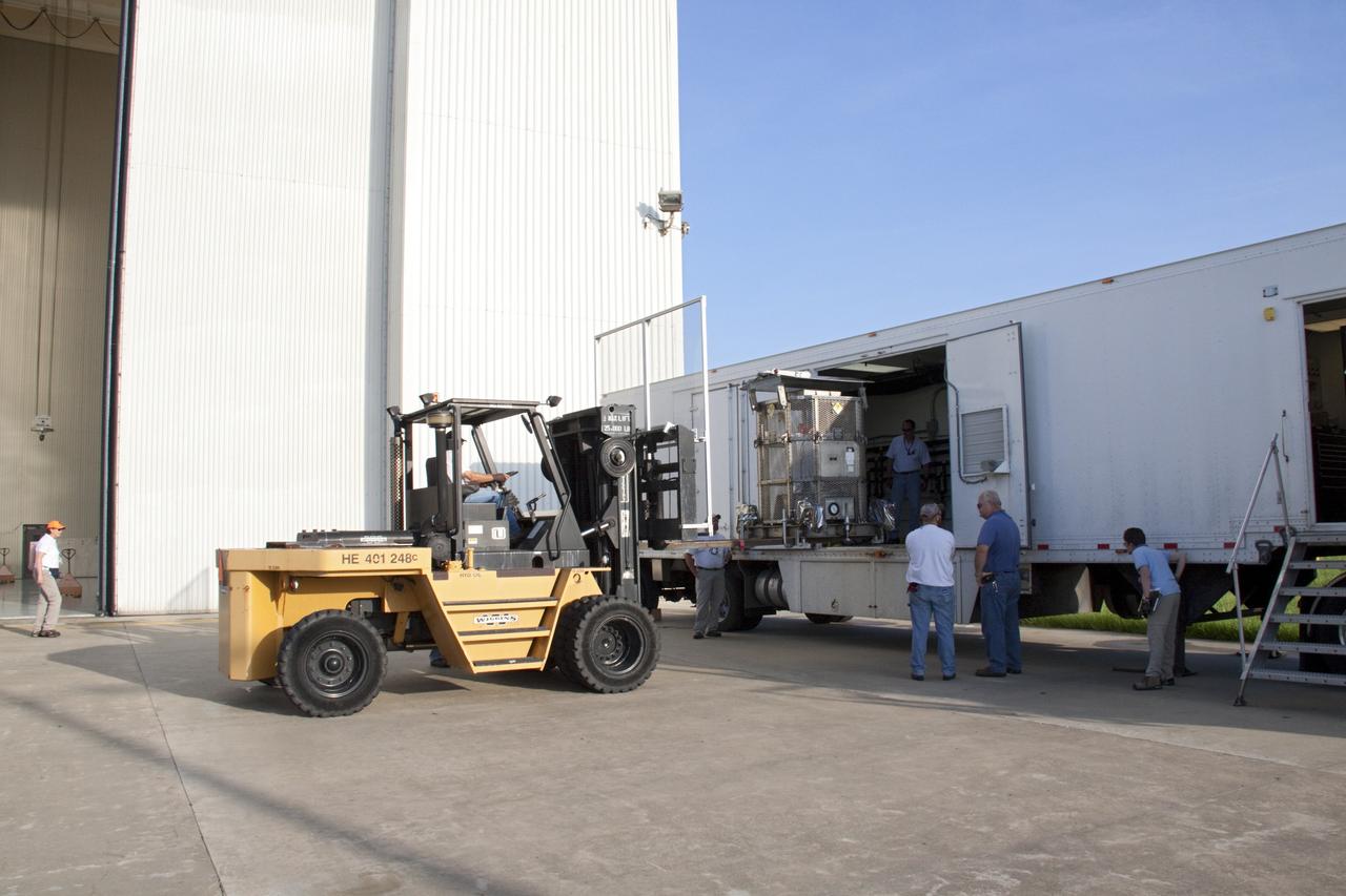 CAPE CANAVERAL, Fla. -- At NASA's Kennedy Space Center in Florida, a forklift lifts the multi-mission radioisotope thermoelectric generator (MMRTG) for NASA's Mars Science Laboratory (MSL) mission into the MMRTG trailer.  The MMRTG is enclosed in a mesh container, known as the "gorilla cage," which protects it during transport and allows any excess heat generated to dissipate into the air.  The MMRTG is being moved to the RTG storage facility following a fit check on MSL's Curiosity rover in the Payload Hazardous Servicing Facility (PHSF).    The MMRTG will generate the power needed for the mission from the natural decay of plutonium-238, a non-weapons-grade form of the radioisotope. Heat given off by this natural decay will provide constant power through the day and night during all seasons. MSL's components include a compact car-sized rover, Curiosity, which has 10 science instruments designed to search for signs of life, including methane, and help determine if the gas is from a biological or geological source. Waste heat from the MMRTG will be circulated throughout the rover system to keep instruments, computers, mechanical devices and communications systems within their operating temperature ranges. Launch of MSL aboard a United Launch Alliance Atlas V rocket is targeted for Nov. 25 from Space Launch Complex 41 on Cape Canaveral Air Force Station. For more information, visit http://www.nasa.gov/msl. Photo credit: NASA/Troy Cryder