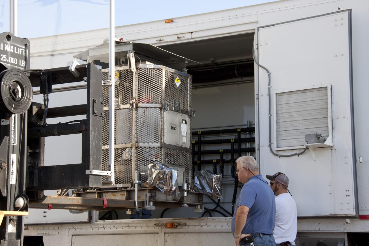CAPE CANAVERAL, Fla. -- At NASA's Kennedy Space Center in Florida, a forklift lifts the multi-mission radioisotope thermoelectric generator (MMRTG) for NASA's Mars Science Laboratory (MSL) mission into the MMRTG trailer.  The MMRTG is enclosed in a mesh container, known as the "gorilla cage," which protects it during transport and allows any excess heat generated to dissipate into the air.  The MMRTG is being moved to the RTG storage facility following a fit check on MSL's Curiosity rover in the Payload Hazardous Servicing Facility (PHSF).    The MMRTG will generate the power needed for the mission from the natural decay of plutonium-238, a non-weapons-grade form of the radioisotope. Heat given off by this natural decay will provide constant power through the day and night during all seasons. MSL's components include a compact car-sized rover, Curiosity, which has 10 science instruments designed to search for signs of life, including methane, and help determine if the gas is from a biological or geological source. Waste heat from the MMRTG will be circulated throughout the rover system to keep instruments, computers, mechanical devices and communications systems within their operating temperature ranges. Launch of MSL aboard a United Launch Alliance Atlas V rocket is targeted for Nov. 25 from Space Launch Complex 41 on Cape Canaveral Air Force Station. For more information, visit http://www.nasa.gov/msl. Photo credit: NASA/Troy Cryder