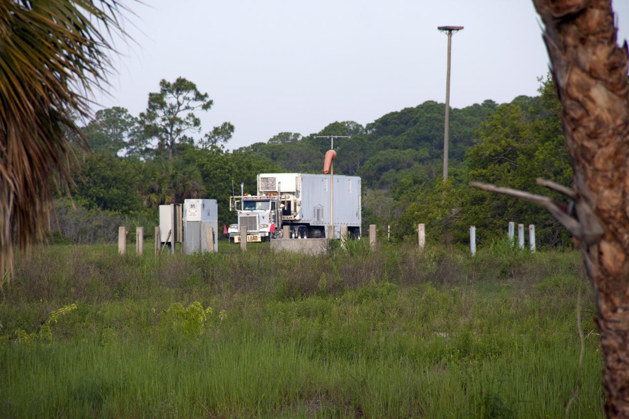 CAPE CANAVERAL, Fla. -- At NASA's Kennedy Space Center in Florida, the multi-mission radioisotope thermoelectric generator (MMRTG) for NASA's Mars Science Laboratory (MSL) mission, secured inside the MMRTG trailer, makes its way between the Payload Hazardous Servicing Facility (PHSF) and the RTG storage facility.  The MMRTG is being moved following a fit check on MSL's Curiosity rover in the PHSF.    The MMRTG will generate the power needed for the mission from the natural decay of plutonium-238, a non-weapons-grade form of the radioisotope. Heat given off by this natural decay will provide constant power through the day and night during all seasons. MSL's components include a compact car-sized rover, Curiosity, which has 10 science instruments designed to search for signs of life, including methane, and help determine if the gas is from a biological or geological source. Waste heat from the MMRTG will be circulated throughout the rover system to keep instruments, computers, mechanical devices and communications systems within their operating temperature ranges. Launch of MSL aboard a United Launch Alliance Atlas V rocket is targeted for Nov. 25 from Space Launch Complex 41 on Cape Canaveral Air Force Station. For more information, visit http://www.nasa.gov/msl. Photo credit: NASA/Troy Cryder