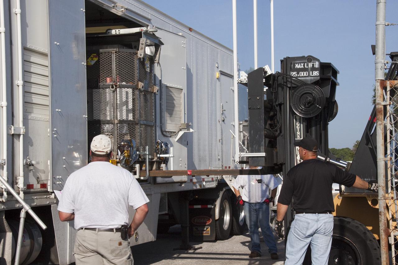 CAPE CANAVERAL, Fla. -- The multi-mission radioisotope thermoelectric generator (MMRTG) for NASA's Mars Science Laboratory (MSL) mission is lifted from the MMRTG trailer at the RTG storage facility (RTGF) at NASA's Kennedy Space Center in Florida. The MMRTG is enclosed in a mesh container, known as the "gorilla cage," which protects it during transport and allows any excess heat generated to dissipate into the air.  The MMRTG is returning to the RTGF following a fit check on MSL's Curiosity rover in the Payload Hazardous Servicing Facility (PHSF).    The MMRTG will generate the power needed for the mission from the natural decay of plutonium-238, a non-weapons-grade form of the radioisotope. Heat given off by this natural decay will provide constant power through the day and night during all seasons. MSL's components include a compact car-sized rover, Curiosity, which has 10 science instruments designed to search for signs of life, including methane, and help determine if the gas is from a biological or geological source. Waste heat from the MMRTG will be circulated throughout the rover system to keep instruments, computers, mechanical devices and communications systems within their operating temperature ranges. Launch of MSL aboard a United Launch Alliance Atlas V rocket is targeted for Nov. 25 from Space Launch Complex 41 on Cape Canaveral Air Force Station. For more information, visit http://www.nasa.gov/msl. Photo credit: NASA/Troy Cryder