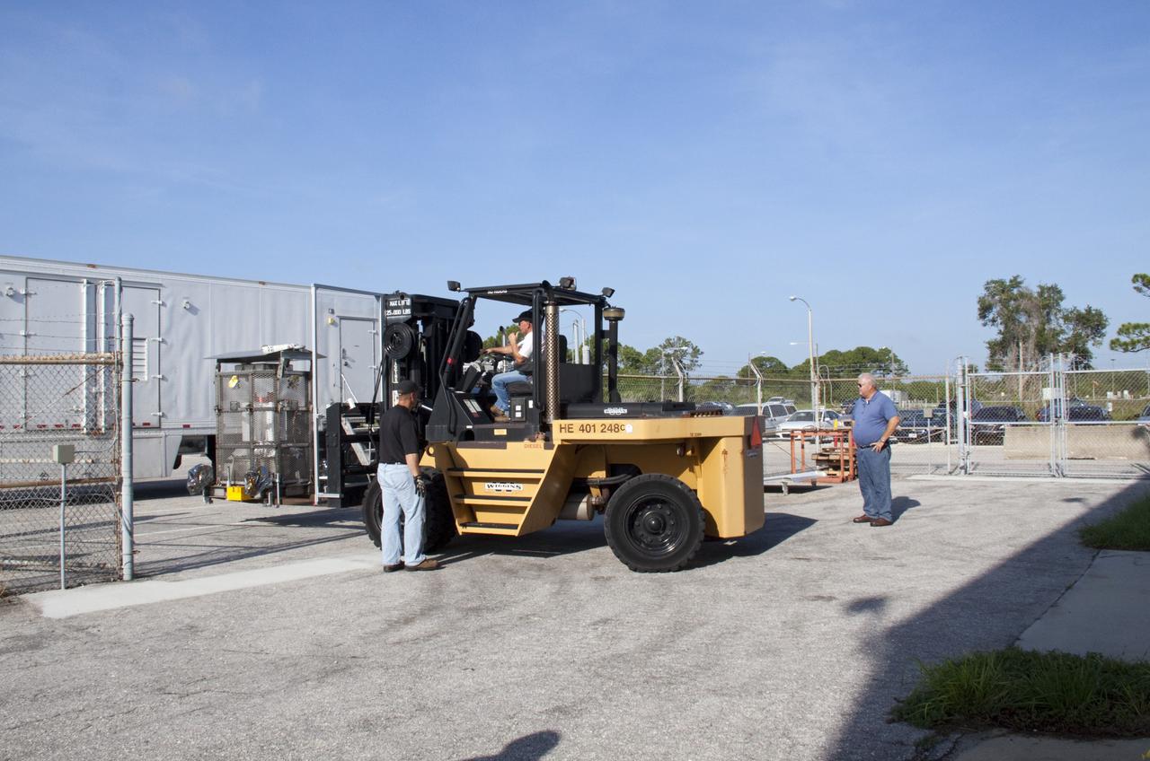 CAPE CANAVERAL, Fla. -- A forklift moves the multi-mission radioisotope thermoelectric generator (MMRTG) for NASA's Mars Science Laboratory (MSL) mission from the MMRTG trailer to the RTG storage facility (RTGF) at NASA's Kennedy Space Center in Florida. The MMRTG is enclosed in a mesh container, known as the "gorilla cage," which protects it during transport and allows any excess heat generated to dissipate into the air.  The MMRTG is returning to the RTGF following a fit check on MSL's Curiosity rover in the Payload Hazardous Servicing Facility (PHSF).    The MMRTG will generate the power needed for the mission from the natural decay of plutonium-238, a non-weapons-grade form of the radioisotope. Heat given off by this natural decay will provide constant power through the day and night during all seasons. MSL's components include a compact car-sized rover, Curiosity, which has 10 science instruments designed to search for signs of life, including methane, and help determine if the gas is from a biological or geological source. Waste heat from the MMRTG will be circulated throughout the rover system to keep instruments, computers, mechanical devices and communications systems within their operating temperature ranges. Launch of MSL aboard a United Launch Alliance Atlas V rocket is targeted for Nov. 25 from Space Launch Complex 41 on Cape Canaveral Air Force Station. For more information, visit http://www.nasa.gov/msl. Photo credit: NASA/Troy Cryder