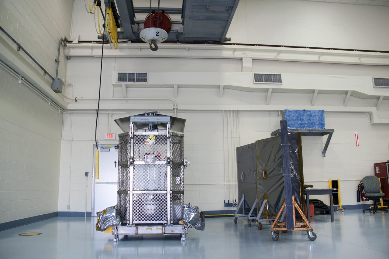 CAPE CANAVERAL, Fla. -- A crane is positioned over the multi-mission radioisotope thermoelectric generator (MMRTG) for NASA's Mars Science Laboratory (MSL) mission in the high bay of the RTG storage facility (RTGF) at NASA's Kennedy Space Center in Florida.  Preparations are under way to lift the mesh container, known as the "gorilla cage," from the support base on which the MMRTG is resting. The cage protects the MMRTG during transport and allows any excess heat generated to dissipate into the air.  The MMRTG is returning to the RTGF following a fit check on MSL's Curiosity rover in the Payload Hazardous Servicing Facility (PHSF).    The MMRTG will generate the power needed for the mission from the natural decay of plutonium-238, a non-weapons-grade form of the radioisotope. Heat given off by this natural decay will provide constant power through the day and night during all seasons. MSL's components include a compact car-sized rover, Curiosity, which has 10 science instruments designed to search for signs of life, including methane, and help determine if the gas is from a biological or geological source. Waste heat from the MMRTG will be circulated throughout the rover system to keep instruments, computers, mechanical devices and communications systems within their operating temperature ranges. Launch of MSL aboard a United Launch Alliance Atlas V rocket is targeted for Nov. 25 from Space Launch Complex 41 on Cape Canaveral Air Force Station. For more information, visit http://www.nasa.gov/msl. Photo credit: NASA/Troy Cryder