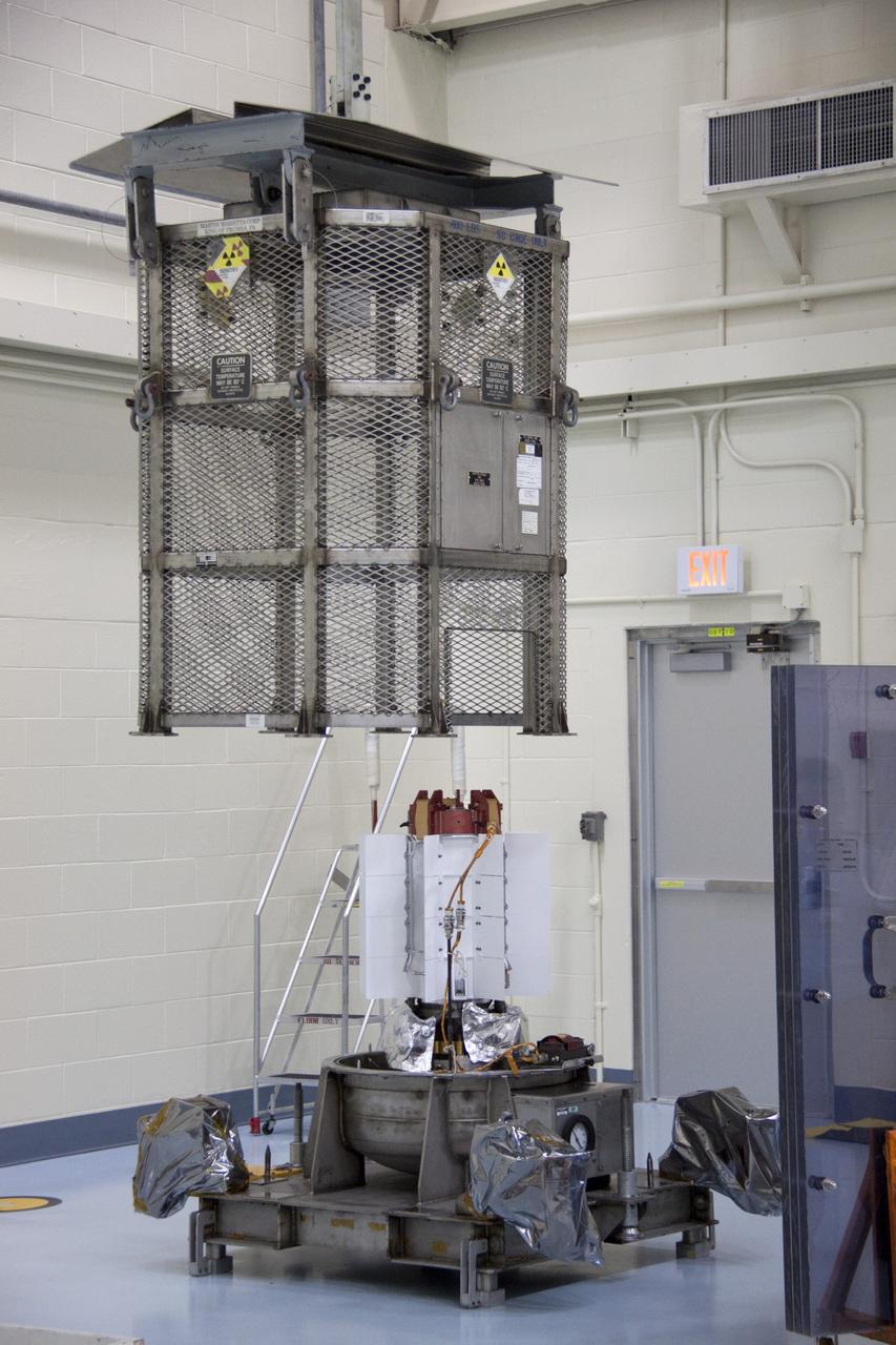 CAPE CANAVERAL, Fla. -- In the high bay of the RTG storage facility (RTGF) at NASA's Kennedy Space Center in Florida, the mesh container enclosing the multi-mission radioisotope thermoelectric generator (MMRTG) for NASA's Mars Science Laboratory (MSL) mission is lifted from around the MMRTG. The container, known as the "gorilla cage," protects the MMRTG during transport and allows any excess heat generated to dissipate into the air.  The cage is being removed following the return of the MMRTG to the RTGF from a fit check on MSL's Curiosity rover in the Payload Hazardous Servicing Facility (PHSF).    The MMRTG will generate the power needed for the mission from the natural decay of plutonium-238, a non-weapons-grade form of the radioisotope. Heat given off by this natural decay will provide constant power through the day and night during all seasons. MSL's components include a compact car-sized rover, Curiosity, which has 10 science instruments designed to search for signs of life, including methane, and help determine if the gas is from a biological or geological source. Waste heat from the MMRTG will be circulated throughout the rover system to keep instruments, computers, mechanical devices and communications systems within their operating temperature ranges. Launch of MSL aboard a United Launch Alliance Atlas V rocket is targeted for Nov. 25 from Space Launch Complex 41 on Cape Canaveral Air Force Station. For more information, visit http://www.nasa.gov/msl. Photo credit: NASA/Troy Cryder