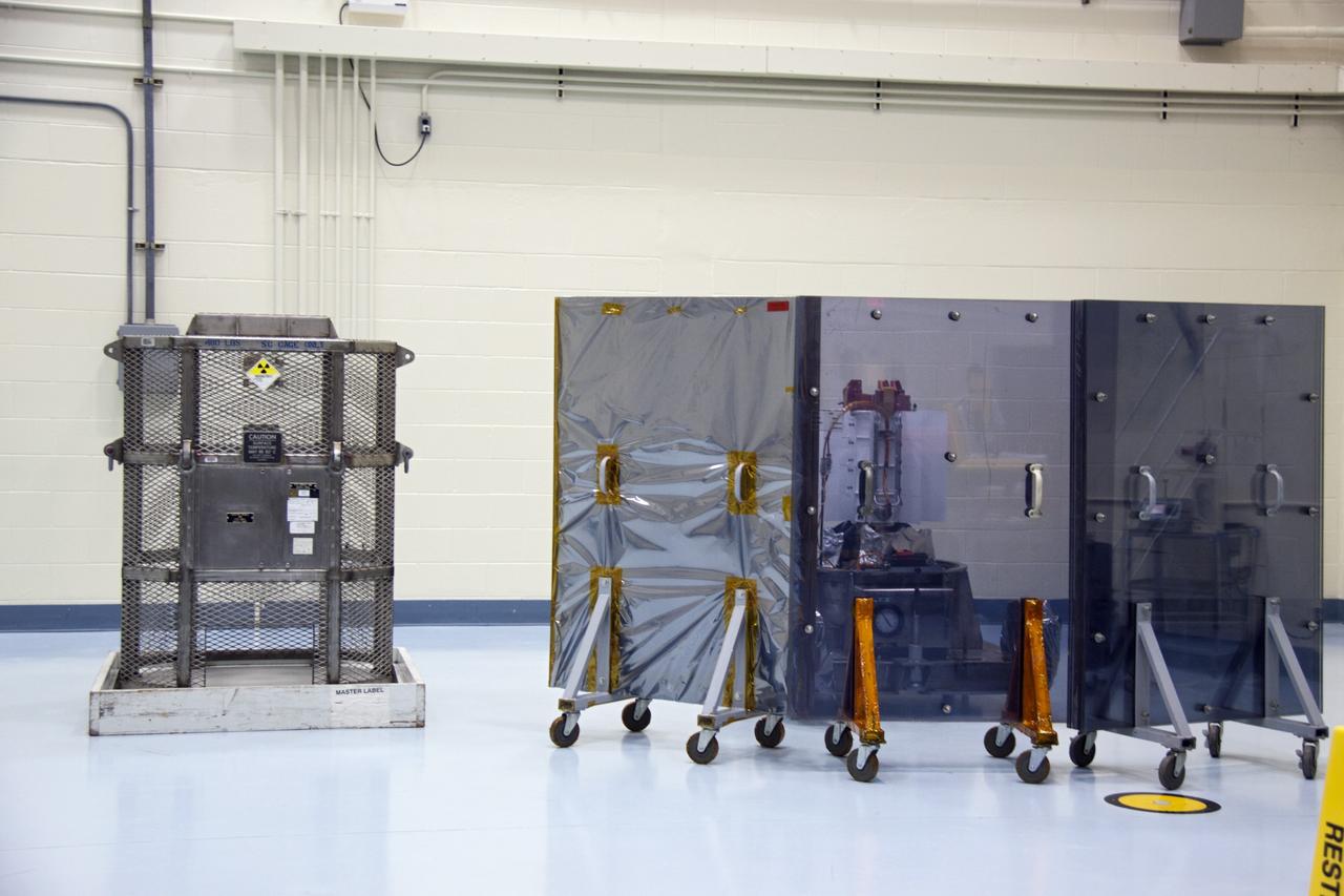 CAPE CANAVERAL, Fla. -- The multi-mission radioisotope thermoelectric generator (MMRTG) for NASA's Mars Science Laboratory (MSL) mission is position behind mobile plexiglass radiation shields in the high bay of the RTG storage facility (RTGF) at NASA's Kennedy Space Center in Florida.  The MMRTG was returned to the RTGF following a fit check on MSL's Curiosity rover in the Payload Hazardous Servicing Facility (PHSF).  The generator will remain in the RTGF until is moved to the pad for integration on the rover.    The MMRTG will generate the power needed for the mission from the natural decay of plutonium-238, a non-weapons-grade form of the radioisotope. Heat given off by this natural decay will provide constant power through the day and night during all seasons. MSL's components include a compact car-sized rover, Curiosity, which has 10 science instruments designed to search for signs of life, including methane, and help determine if the gas is from a biological or geological source. Waste heat from the MMRTG will be circulated throughout the rover system to keep instruments, computers, mechanical devices and communications systems within their operating temperature ranges. Launch of MSL aboard a United Launch Alliance Atlas V rocket is targeted for Nov. 25 from Space Launch Complex 41 on Cape Canaveral Air Force Station. For more information, visit http://www.nasa.gov/msl. Photo credit: NASA/Troy Cryder