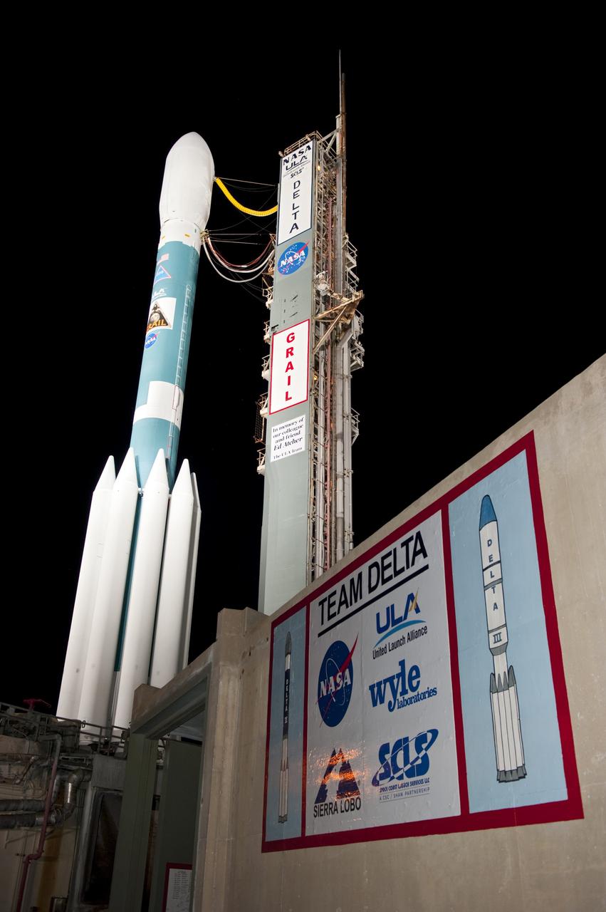 CAPE CANAVERAL, Fla. -- At Space Launch Complex 17B on Cape Canaveral Air Force Station, the United Launch Alliance Delta II rocket that will launch NASA's Gravity Recovery and Interior Laboratory mission towers over the logos painted on the pad's structure of the companies comprising the launch team. The mobile service tower has been rolled away from the vehicle for launch. The "rollback" began at about 11:20 p.m. EDT Sept. 7. GRAIL will fly twin spacecraft in tandem around the moon to precisely measure and map variations in the moon's gravitational field. The mission will provide the most accurate global gravity field to date for any planet, including Earth. This detailed information will reveal differences in the density of the moon's crust and mantle and will help answer fundamental questions about the moon's internal structure, thermal evolution, and history of collisions with asteroids. The aim is to map the moon's gravity field so completely that future lunar vehicles can safely navigate anywhere on the moon’s surface. Launch is scheduled for 8:37:06 a.m. EDT Sept. 8. For more information, visit http://www.nasa.gov/grail. Photo credit: NASA/Kim Shiflett
