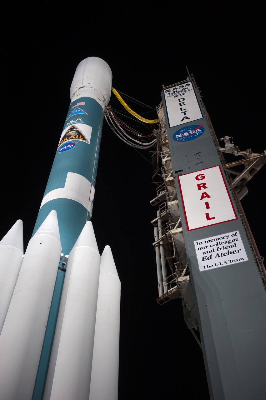 CAPE CANAVERAL, Fla. -- At Space Launch Complex 17B on Cape Canaveral Air Force Station, United Launch Alliance (ULA) honors the late Ed Atcher with a placard posted on the service tower next to the ULA Delta II rocket that will launch NASA's Gravity Recovery and Interior Laboratory mission. The mobile service tower has been rolled away from the vehicle for launch.  The "rollback" began at about 11:20 p.m. EDT Sept. 7.    GRAIL will fly twin spacecraft in tandem around the moon to precisely measure and map variations in the moon's gravitational field. The mission will provide the most accurate global gravity field to date for any planet, including Earth. This detailed information will reveal differences in the density of the moon's crust and mantle and will help answer fundamental questions about the moon's internal structure, thermal evolution, and history of collisions with asteroids. The aim is to map the moon's gravity field so completely that future lunar vehicles can safely navigate anywhere on the moon’s surface.  Launch is scheduled for 8:37:06 a.m. EDT Sept. 8.  For more information, visit http://www.nasa.gov/grail. Photo credit: NASA/Kim Shiflett