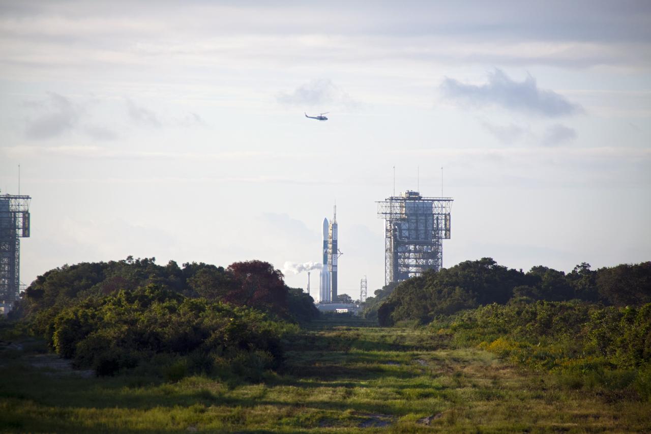 CAPE CANAVERAL, Fla. -- A surveillance helicopter passes over Space Launch Complex 17B on Cape Canaveral Air Force Station where preparations to launch the United Launch Alliance Delta II Heavy rocket that will carry NASA's Gravity Recovery and Interior Laboratory mission into space are being completed.     GRAIL will fly twin spacecraft in tandem around the moon to precisely measure and map variations in the moon's gravitational field. The mission will provide the most accurate global gravity field to date for any planet, including Earth. This detailed information will reveal differences in the density of the moon's crust and mantle and will help answer fundamental questions about the moon's internal structure, thermal evolution, and history of collisions with asteroids. The aim is to map the moon's gravity field so completely that future lunar vehicles can safely navigate anywhere on the moon’s surface.  Launch is scheduled for 8:37:06 a.m. EDT Sept. 8.  For more information, visit http://www.nasa.gov/grail. Photo credit: NASA