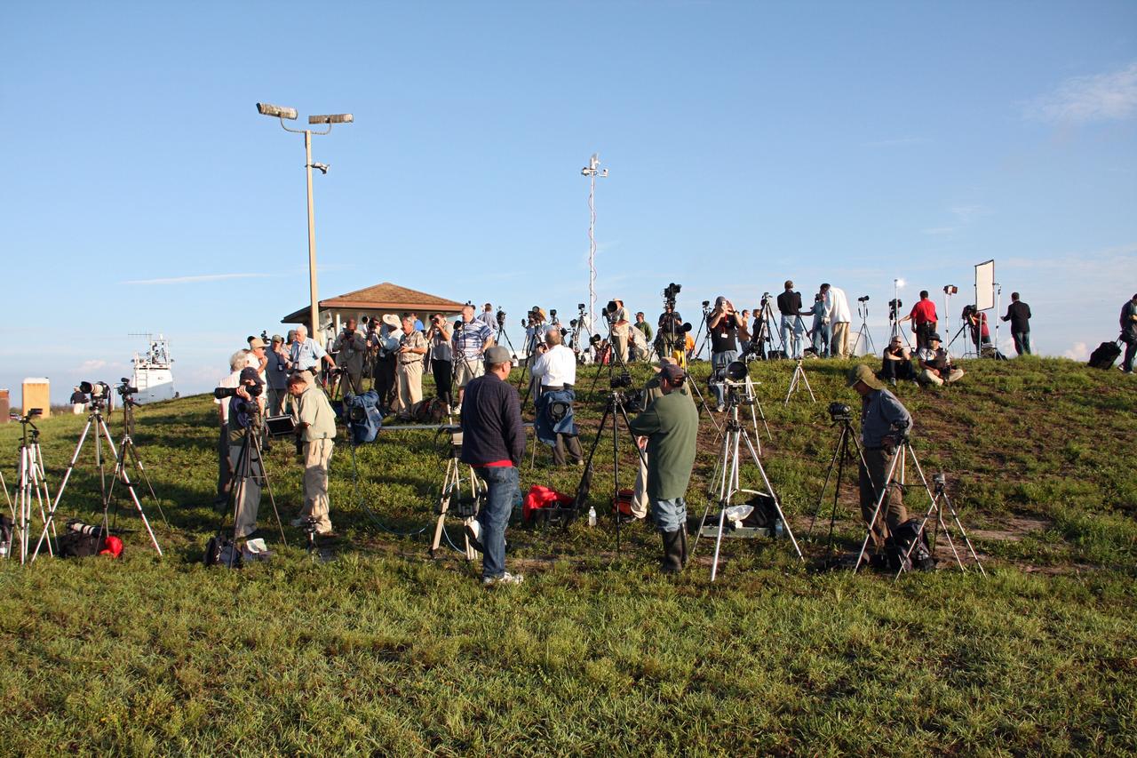 CAPE CANAVERAL, Fla. -- Media representatives set up their camera tripods at Press Site 1 near Space Launch Complex 17B on Cape Canaveral Air Force Station. On tap is the launch of NASA's Gravity Recovery and Interior Laboratory mission. Liftoff aboard a United Launch Alliance Delta II Heavy rocket is scheduled for 8:37:06 a.m. EDT. GRAIL will fly twin spacecraft in tandem around the moon to precisely measure and map variations in the moon's gravitational field. The mission will provide the most accurate global gravity field to date for any planet, including Earth. This detailed information will reveal differences in the density of the moon's crust and mantle and will help answer fundamental questions about the moon's internal structure, thermal evolution, and history of collisions with asteroids. The aim is to map the moon's gravity field so completely that future lunar vehicles can safely navigate anywhere on the moon’s surface. For more information, visit http://www.nasa.gov/grail. Photo credit: NASA/Ken Thornsley