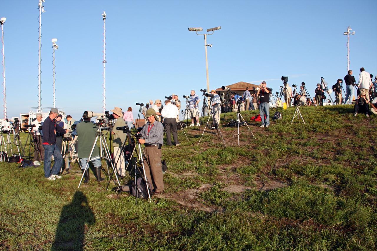 CAPE CANAVERAL, Fla. -- Media representatives prepare to photograph the launch of NASA's Gravity Recovery and Interior Laboratory mission at Press Site 1 near Space Launch Complex 17B on Cape Canaveral Air Force Station. Liftoff aboard a United Launch Alliance Delta II Heavy rocket is scheduled for 8:37:06 a.m. EDT. GRAIL will fly twin spacecraft in tandem around the moon to precisely measure and map variations in the moon's gravitational field. The mission will provide the most accurate global gravity field to date for any planet, including Earth. This detailed information will reveal differences in the density of the moon's crust and mantle and will help answer fundamental questions about the moon's internal structure, thermal evolution, and history of collisions with asteroids. The aim is to map the moon's gravity field so completely that future lunar vehicles can safely navigate anywhere on the moon’s surface. For more information, visit http://www.nasa.gov/grail. Photo credit: NASA/Ken Thornsley