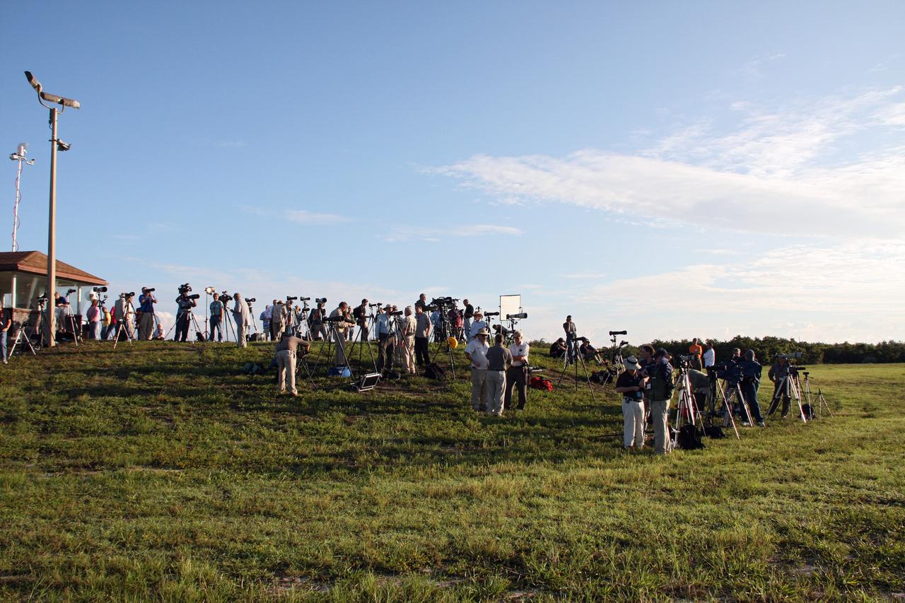 CAPE CANAVERAL, Fla. -- Media representatives vie for the best positions for their camera tripods at Press Site 1 near Space Launch Complex 17B on Cape Canaveral Air Force Station. On tap is the launch of NASA's Gravity Recovery and Interior Laboratory mission. Liftoff aboard a United Launch Alliance Delta II Heavy rocket is scheduled for 8:37:06 a.m. EDT. GRAIL will fly twin spacecraft in tandem around the moon to precisely measure and map variations in the moon's gravitational field. The mission will provide the most accurate global gravity field to date for any planet, including Earth. This detailed information will reveal differences in the density of the moon's crust and mantle and will help answer fundamental questions about the moon's internal structure, thermal evolution, and history of collisions with asteroids. The aim is to map the moon's gravity field so completely that future lunar vehicles can safely navigate anywhere on the moon’s surface. For more information, visit http://www.nasa.gov/grail. Photo credit: NASA/Ken Thornsley