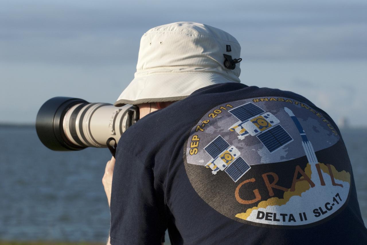 CAPE CANAVERAL, Fla. – A Tweetup participant searches for the right photo angle along the NASA Causeway launch viewing area at NASA’s Kennedy Space Center in Florida during prelaunch activities for the agency’s Gravity Recovery and Interior Laboratory (GRAIL) mission. Participants toured the center and got a close-up view of Space Launch Complex 17B at Cape Canaveral Air Force Station. The tweeters will share their experiences with followers through the social networking site Twitter. GRAIL will fly twin spacecraft in tandem around the moon to precisely measure and map variations in the moon’s gravitational field. The mission will provide the most accurate global gravity field to date for any planet, including Earth. This detailed information will reveal differences in the density of the moon’s crust and mantle and will help answer fundamental questions about the moon’s internal structure, thermal evolution, and history of collisions with asteroids. The aim is to map the moon’s gravity field so completely that future lunar vehicles can safely navigate anywhere on the moon’s surface. Launch is scheduled for 8:37:06 a.m. EDT Sept. 8. For more information, visit http://www.nasa.gov/grail. Photo credit: NASA/Kim Shiflett