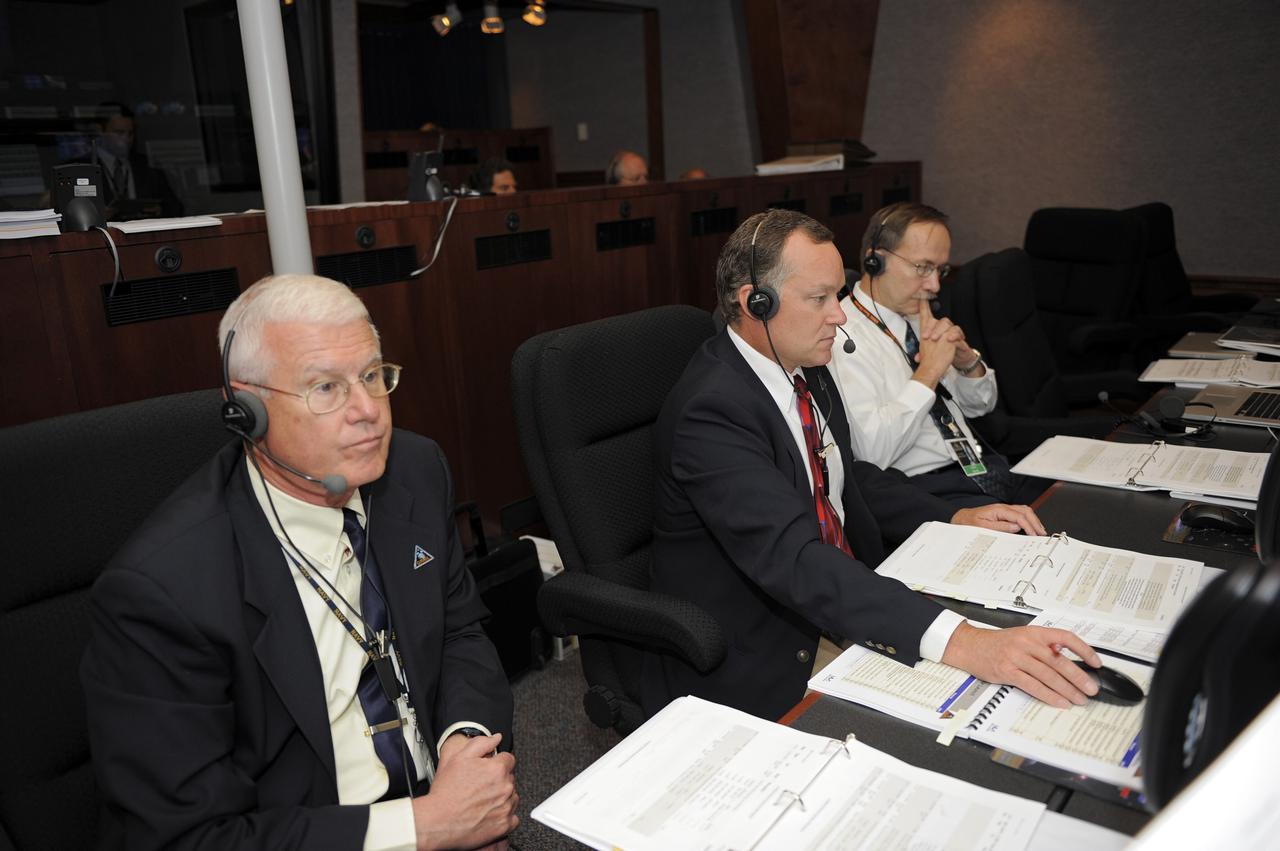 CAPE CANAVERAL, Fla. -- On Cape Canaveral Air Force Station in Florida, members of NASA's Gravity Recovery and Interior Laboratory (GRAIL) launch team monitor GRAIL's launch countdown from the Mission Directors Center in Hangar AE.  From left are David Lehman, spacecraft mission director and GRAIL project manager, NASA's Jet Propulsion Laboratory (JPL); Tom Hoffman, deputy spacecraft mission director, JPL; and John Henk, GRAIL program manager, Lockheed Martin Space Systems.    Launch is scheduled for 8:37:06 a.m. EDT Sept. 8 from Space Launch Complex 17B on Cape Canaveral Air Force Station.  GRAIL will fly twin spacecraft in tandem around the moon to precisely measure and map variations in the moon's gravitational field. The mission will provide the most accurate global gravity field to date for any planet, including Earth.  For more information, visit http://www.nasa.gov/grail. Photo credit: NASA/Kim Shiflett