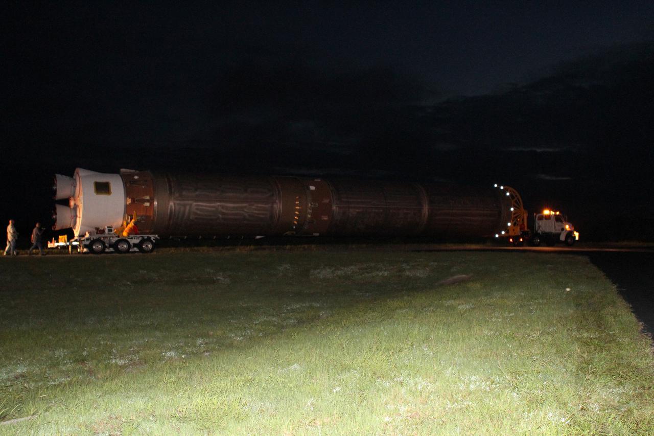CAPE CANAVERAL, Fla. -- Workers accompany the first stage of the Atlas V rocket for NASA's Mars Science Laboratory (MSL) mission on its trip from the Atlas Spaceflight Operations Center on Cape Canaveral Air Force Station in Florida to the launch pad.    A United Launch Alliance Atlas V-541 configuration will be used to loft MSL into space. Curiosity’s 10 science instruments are designed to search for evidence on whether Mars has had environments favorable to microbial life, including chemical ingredients for life.  The unique rover will use a laser to look inside rocks and release its gasses so that the rover’s spectrometer can analyze and send the data back to Earth. MSL is scheduled to launch Nov. 25 with a window extending to Dec. 18 and arrival at Mars Aug. 2012. For more information, visit http://www.nasa.gov/msl. Photo credit: NASA/Cory Huston