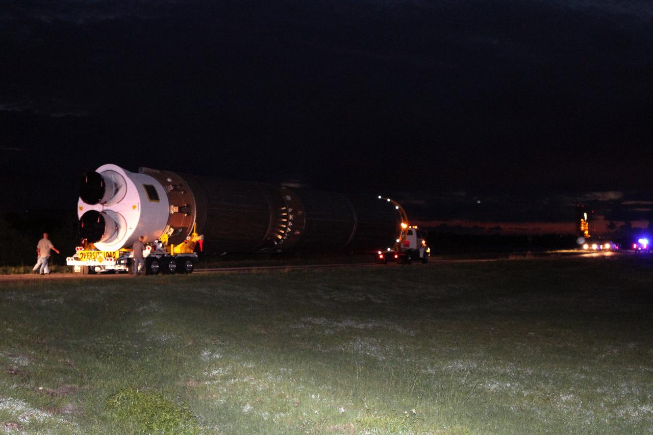 CAPE CANAVERAL, Fla. -- Early morning finds workers accompanying the first stage of the Atlas V rocket for NASA's Mars Science Laboratory (MSL) mission on its move from the Atlas Spaceflight Operations Center on Cape Canaveral Air Force Station in Florida to the launch pad.    A United Launch Alliance Atlas V-541 configuration will be used to loft MSL into space. Curiosity’s 10 science instruments are designed to search for evidence on whether Mars has had environments favorable to microbial life, including chemical ingredients for life.  The unique rover will use a laser to look inside rocks and release its gasses so that the rover’s spectrometer can analyze and send the data back to Earth. MSL is scheduled to launch Nov. 25 with a window extending to Dec. 18 and arrival at Mars Aug. 2012. For more information, visit http://www.nasa.gov/msl. Photo credit: NASA/Cory Huston