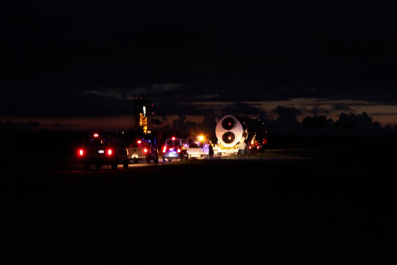 CAPE CANAVERAL, Fla. -- A convoy of support vehicles trails the first stage of the Atlas V rocket for NASA's Mars Science Laboratory (MSL) mission as it moves from the Atlas Spaceflight Operations Center on Cape Canaveral Air Force Station in Florida to the launch pad.    A United Launch Alliance Atlas V-541 configuration will be used to loft MSL into space. Curiosity’s 10 science instruments are designed to search for evidence on whether Mars has had environments favorable to microbial life, including chemical ingredients for life.  The unique rover will use a laser to look inside rocks and release its gasses so that the rover’s spectrometer can analyze and send the data back to Earth. MSL is scheduled to launch Nov. 25 with a window extending to Dec. 18 and arrival at Mars Aug. 2012. For more information, visit http://www.nasa.gov/msl. Photo credit: NASA/Cory Huston