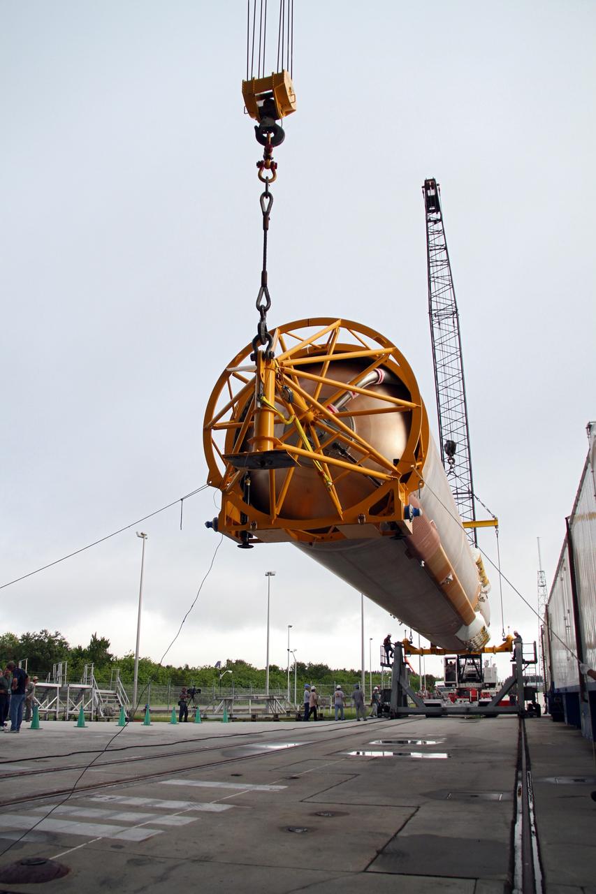CAPE CANAVERAL, Fla. -- The first stage of the Atlas V rocket for NASA's Mars Science Laboratory (MSL) mission is suspended over the concrete surface outside the Vertical Integration Facility at Space Launch Complex 41 on Cape Canaveral Air Force Station.    A United Launch Alliance Atlas V-541 configuration will be used to loft MSL into space. Curiosity’s 10 science instruments are designed to search for evidence on whether Mars has had environments favorable to microbial life, including chemical ingredients for life.  The unique rover will use a laser to look inside rocks and release its gasses so that the rover’s spectrometer can analyze and send the data back to Earth. MSL is scheduled to launch Nov. 25 with a window extending to Dec. 18 and arrival at Mars Aug. 2012. For more information, visit http://www.nasa.gov/msl. Photo credit: NASA/Cory Huston