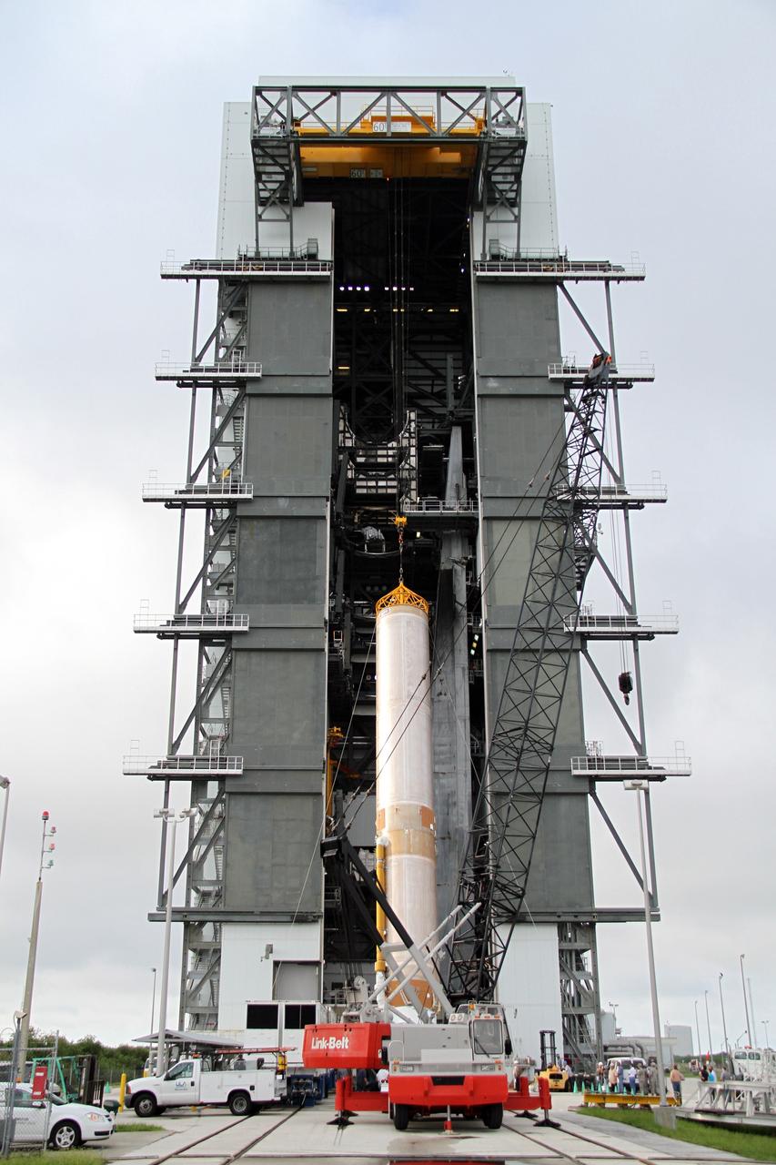 CAPE CANAVERAL, Fla. -- The first stage of the Atlas V rocket for NASA's Mars Science Laboratory (MSL) mission hangs in a vertical position outside the Vertical Integration Facility at Space Launch Complex 41 on Cape Canaveral Air Force Station.    A United Launch Alliance Atlas V-541 configuration will be used to loft MSL into space. Curiosity’s 10 science instruments are designed to search for evidence on whether Mars has had environments favorable to microbial life, including chemical ingredients for life.  The unique rover will use a laser to look inside rocks and release its gasses so that the rover’s spectrometer can analyze and send the data back to Earth. MSL is scheduled to launch Nov. 25 with a window extending to Dec. 18 and arrival at Mars Aug. 2012. For more information, visit http://www.nasa.gov/msl. Photo credit: NASA/Cory Huston