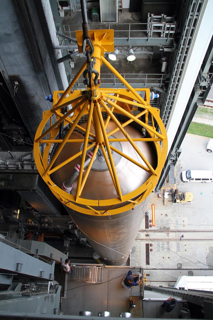 CAPE CANAVERAL, Fla. -- A crane positions the 106.5-foot-long first stage of the Atlas V rocket for NASA's Mars Science Laboratory (MSL) mission inside the Vertical Integration Facility at Space Launch Complex 41 on Cape Canaveral Air Force Station.    A United Launch Alliance Atlas V-541 configuration will be used to loft MSL into space. Curiosity’s 10 science instruments are designed to search for evidence on whether Mars has had environments favorable to microbial life, including chemical ingredients for life.  The unique rover will use a laser to look inside rocks and release its gasses so that the rover’s spectrometer can analyze and send the data back to Earth. MSL is scheduled to launch Nov. 25 with a window extending to Dec. 18 and arrival at Mars Aug. 2012. For more information, visit http://www.nasa.gov/msl. Photo credit: NASA/Cory Huston