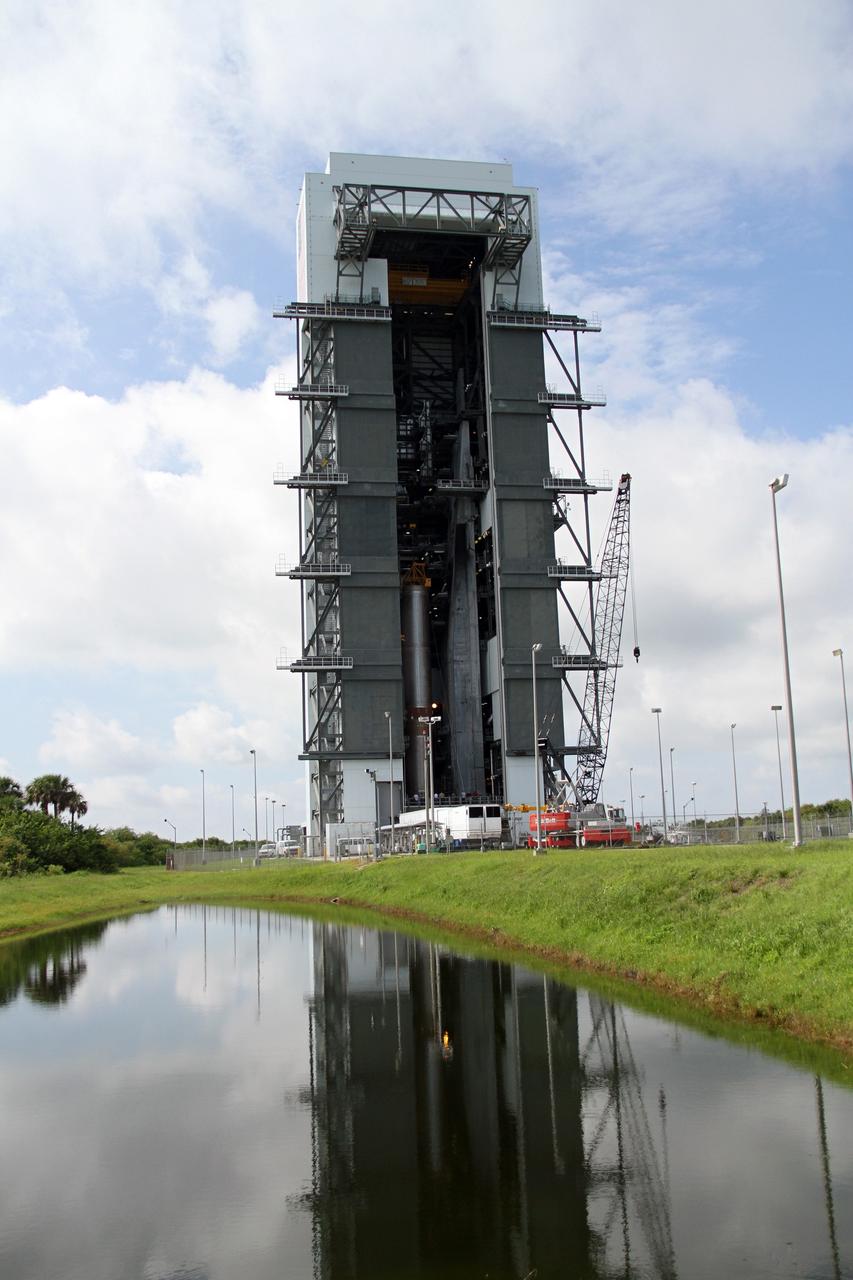 CAPE CANAVERAL, Fla. -- The Vertical Integration Facility is reflected in the water standing near the facility at Space Launch Complex 41 on Cape Canaveral Air Force Station following the arrival of the first stage of the Atlas V rocket for NASA's Mars Science Laboratory (MSL) mission.    A United Launch Alliance Atlas V-541 configuration will be used to loft MSL into space. Curiosity’s 10 science instruments are designed to search for evidence on whether Mars has had environments favorable to microbial life, including chemical ingredients for life.  The unique rover will use a laser to look inside rocks and release its gasses so that the rover’s spectrometer can analyze and send the data back to Earth. MSL is scheduled to launch Nov. 25 with a window extending to Dec. 18 and arrival at Mars Aug. 2012. For more information, visit http://www.nasa.gov/msl. Photo credit: NASA/Cory Huston