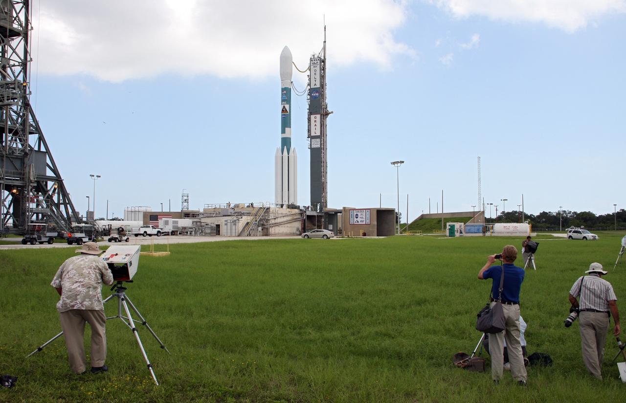 CAPE CANAVERAL, Fla. – News media photograph the United Launch Alliance Delta II heavy rocket carrying NASA’s twin Gravity Recovery and Interior Laboratory spacecraft at Launch Complex 17B as the mobile service tower is rolled back around to the vehicle after the first launch attempt was scrubbed due to upper-level winds. GRAIL is scheduled for another launch attempt Sept.10 at 8:29:45 a.m. EDT. at Cape Canaveral Air Force Station in Florida. GRAIL will fly twin spacecraft in tandem around the moon to precisely measure and map variations in the moon's gravitational field. The mission will provide the most accurate global gravity field to date for any planet, including Earth. This detailed information will reveal differences in the density of the moon's crust and mantle and will help answer fundamental questions about the moon's internal structure, thermal evolution, and history of collisions with asteroids. The aim is to map the moon's gravity field so completely that future moon vehicles can safely navigate anywhere on the moon’s surface. For more information, visit http://www.nasa.gov/grail. Photo credit: NASA/Ken Thornsley